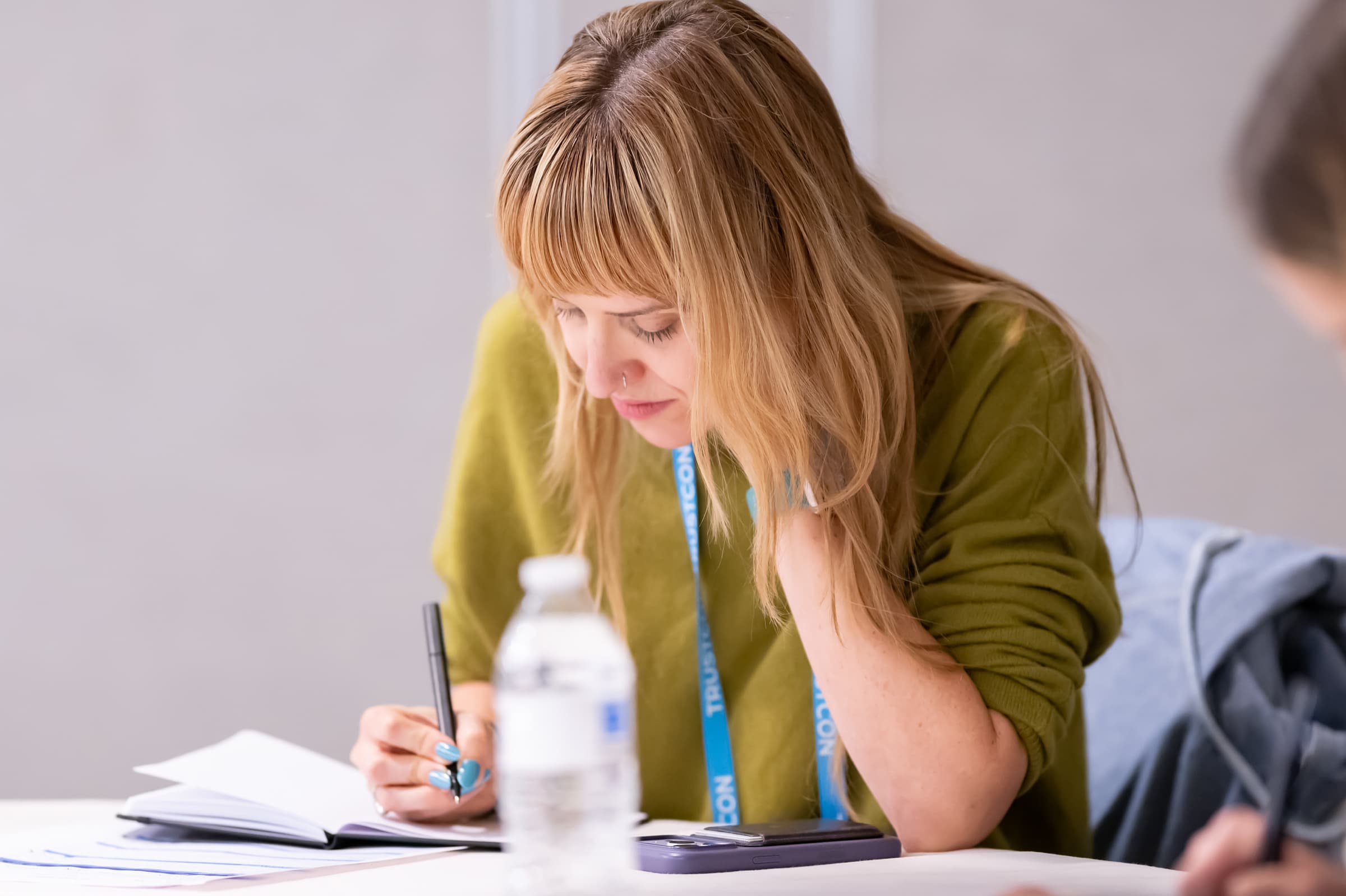Attendee taking notes during a breakout session