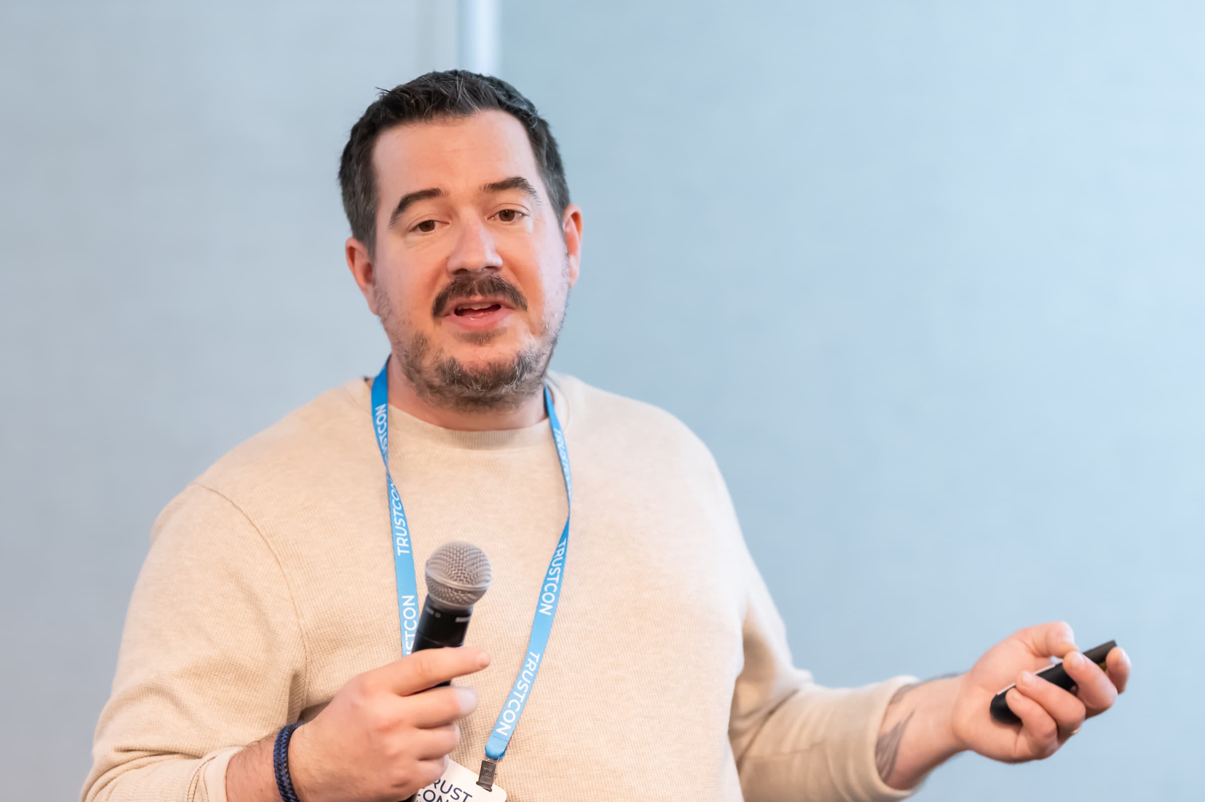 Attendee asking a question with a microphone during a breakout