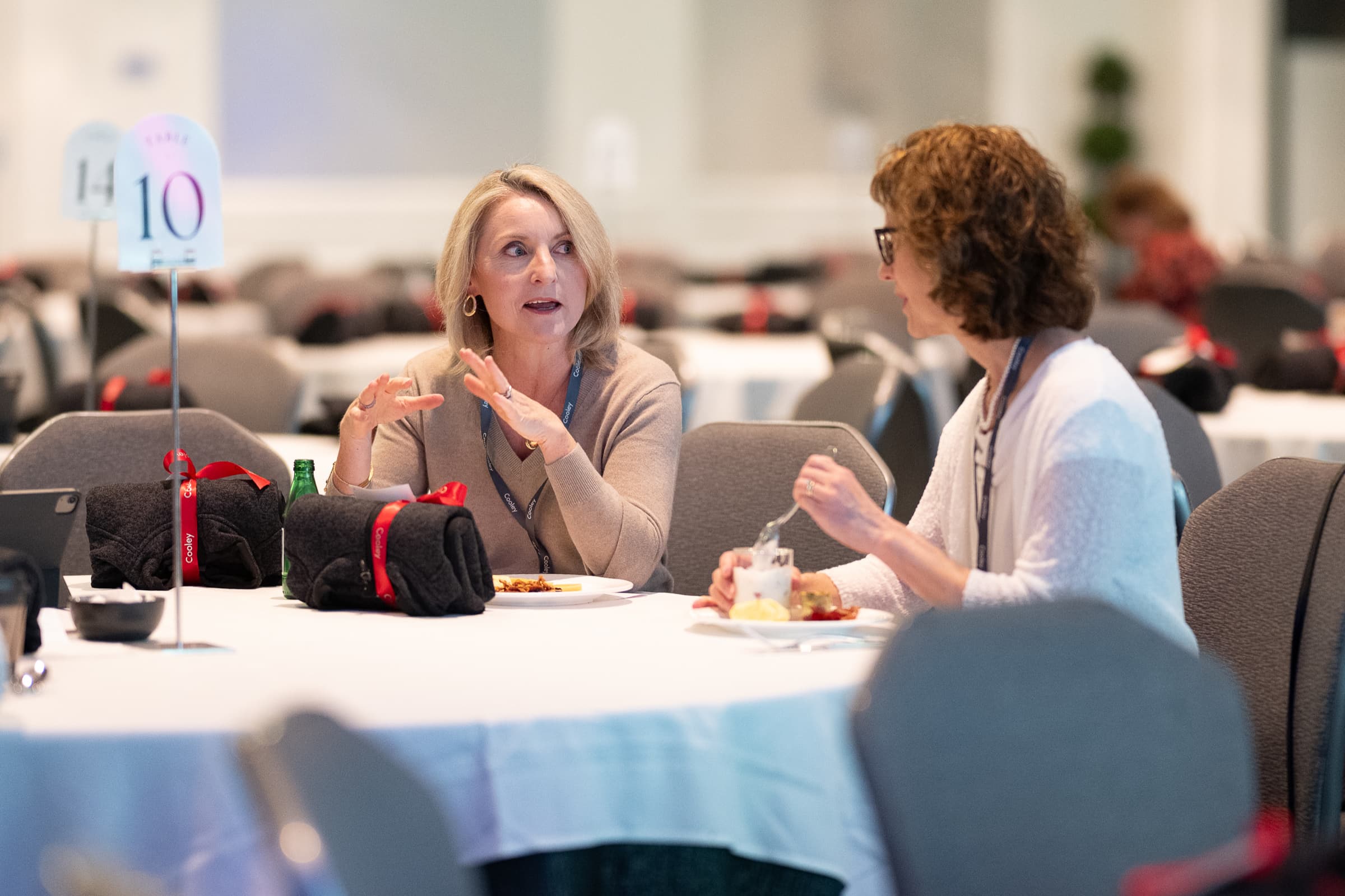 Candid conversation between attendees at a session table