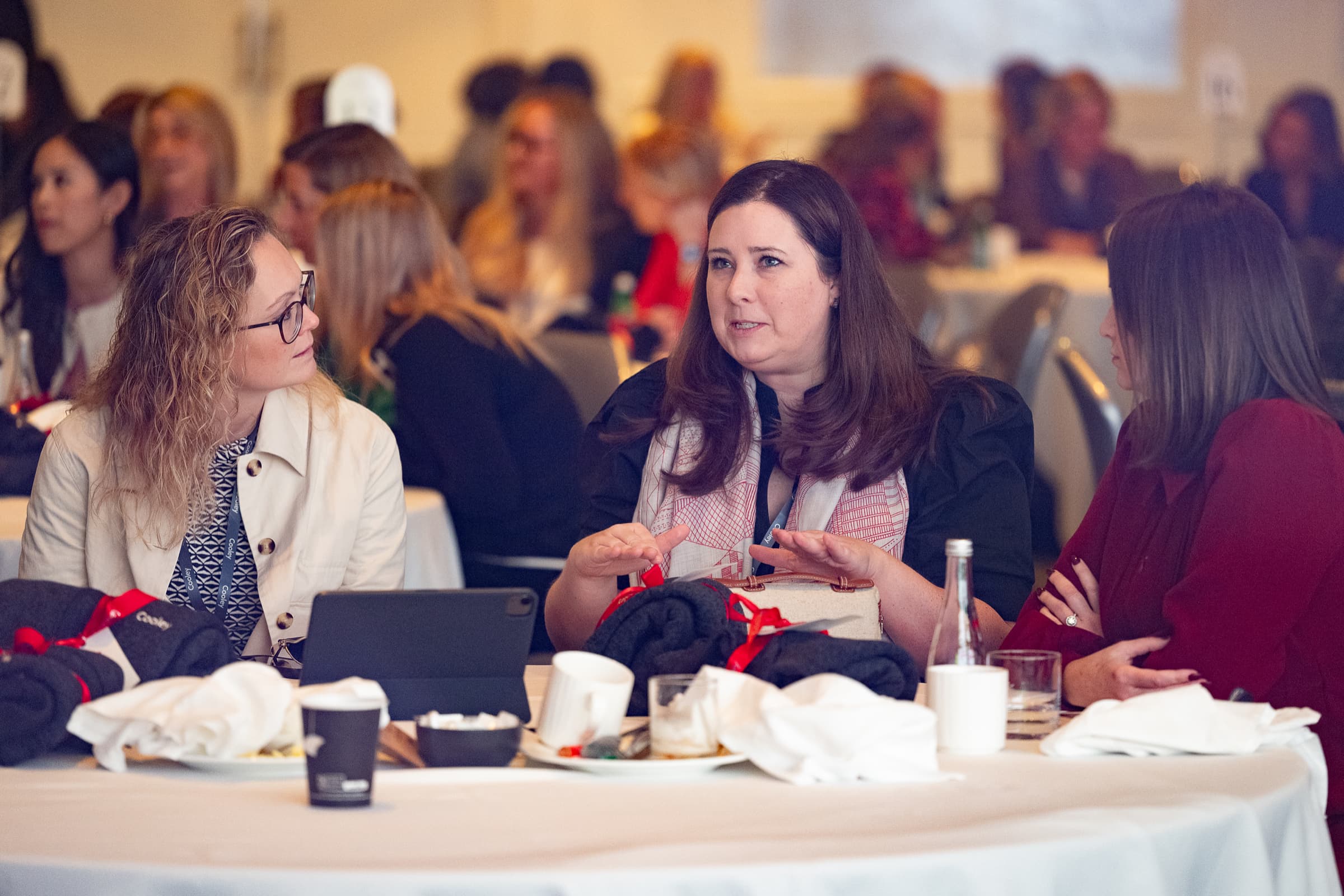 Attendees talking around a table during a working session