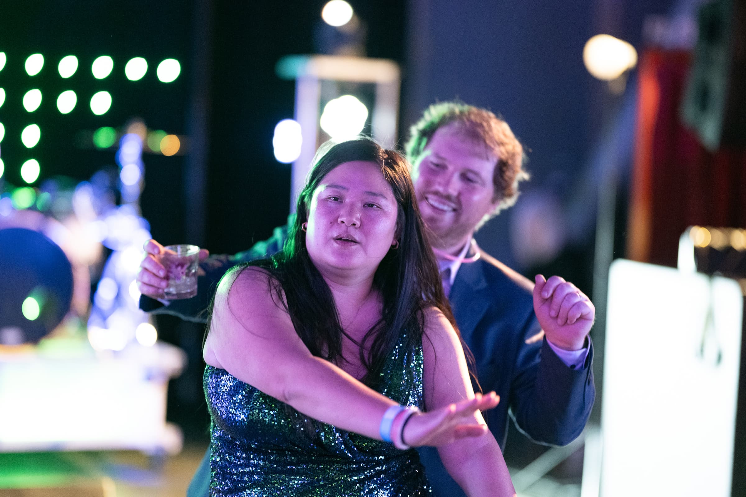 Two guests talking with drinks during an evening event