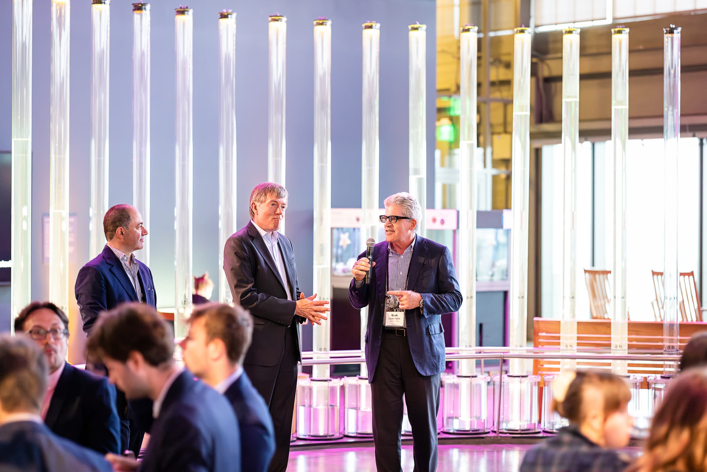 Guests mingling with drinks before a seated dinner