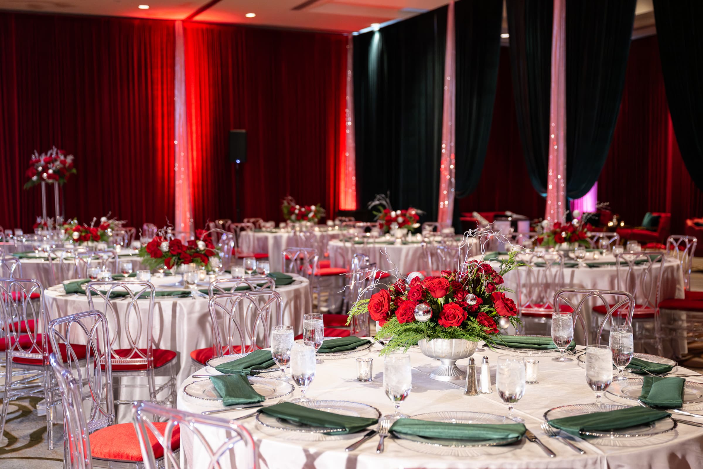 Banquet tables set with glassware and florals before dinner service