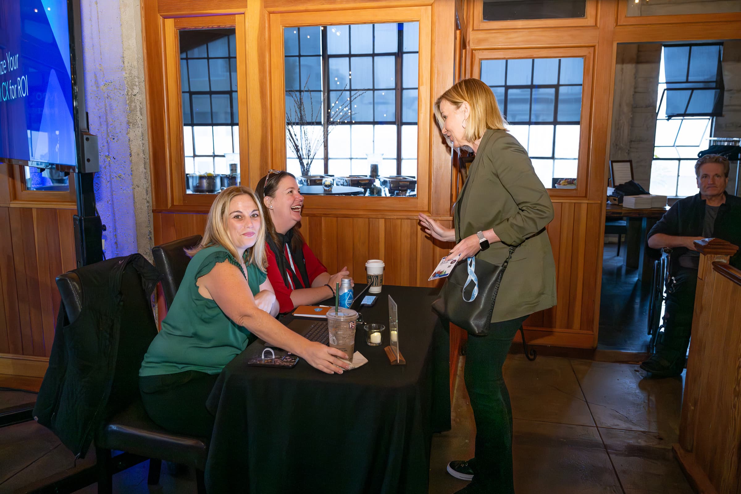 Guests greeting each other at a high table on arrival at a hosted breakfast
