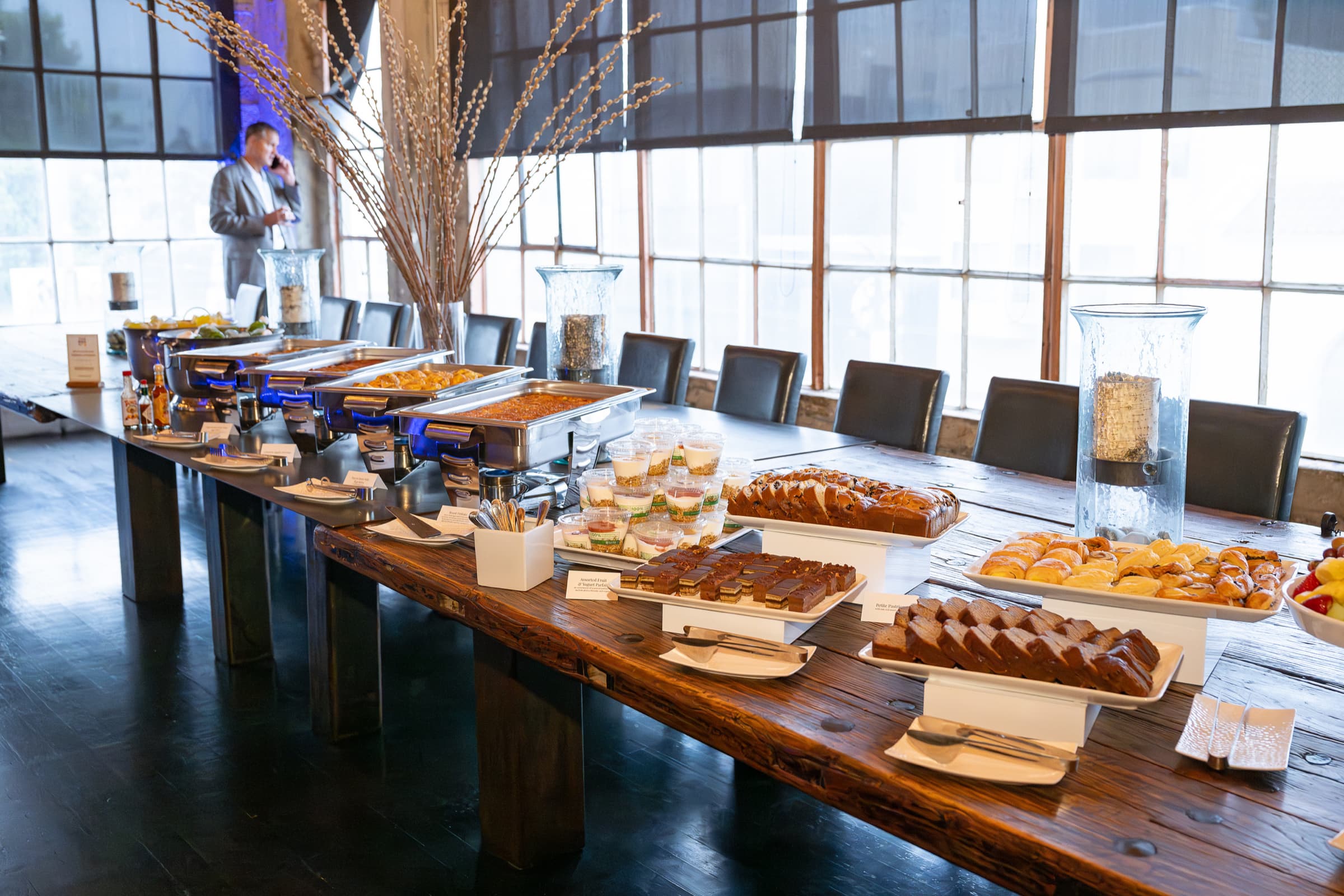 Pastries and breakfast dishes arranged along a communal table