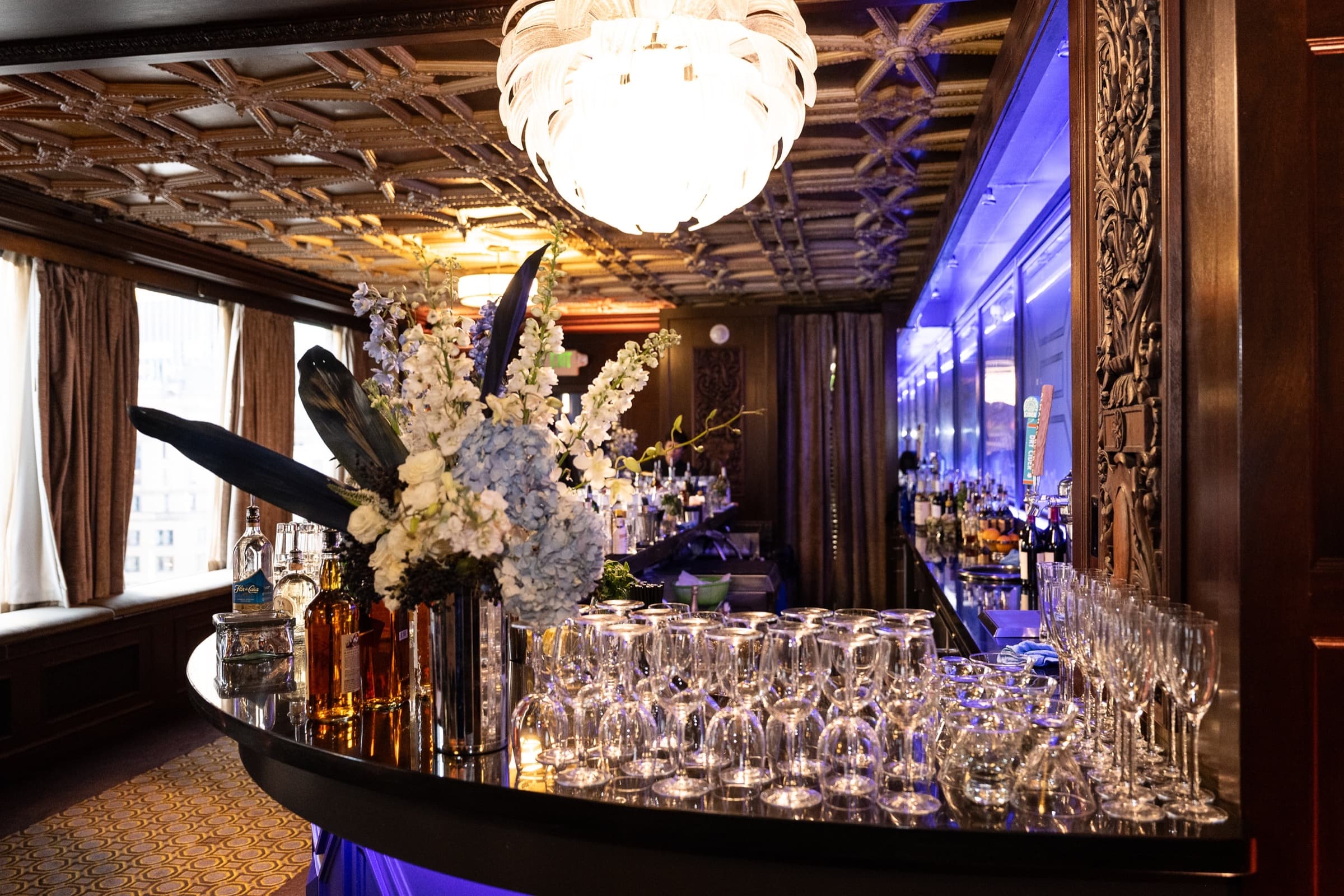 Chandelier, glassware, and florals photographed in a ballroom before an awards program