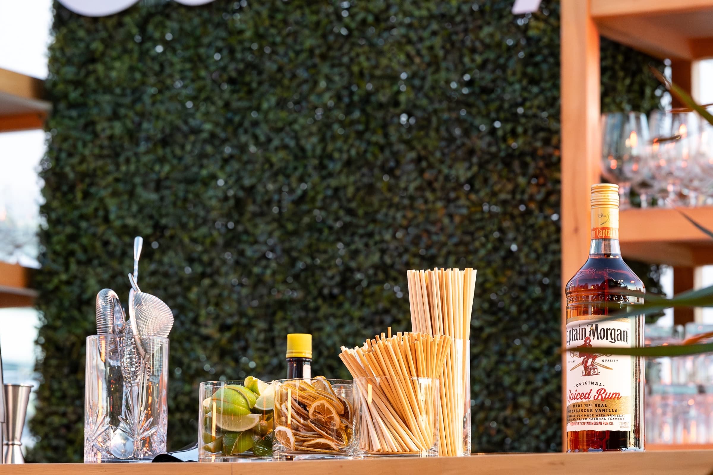 Close detail of cocktail garnishes and bar tools at a reception bar