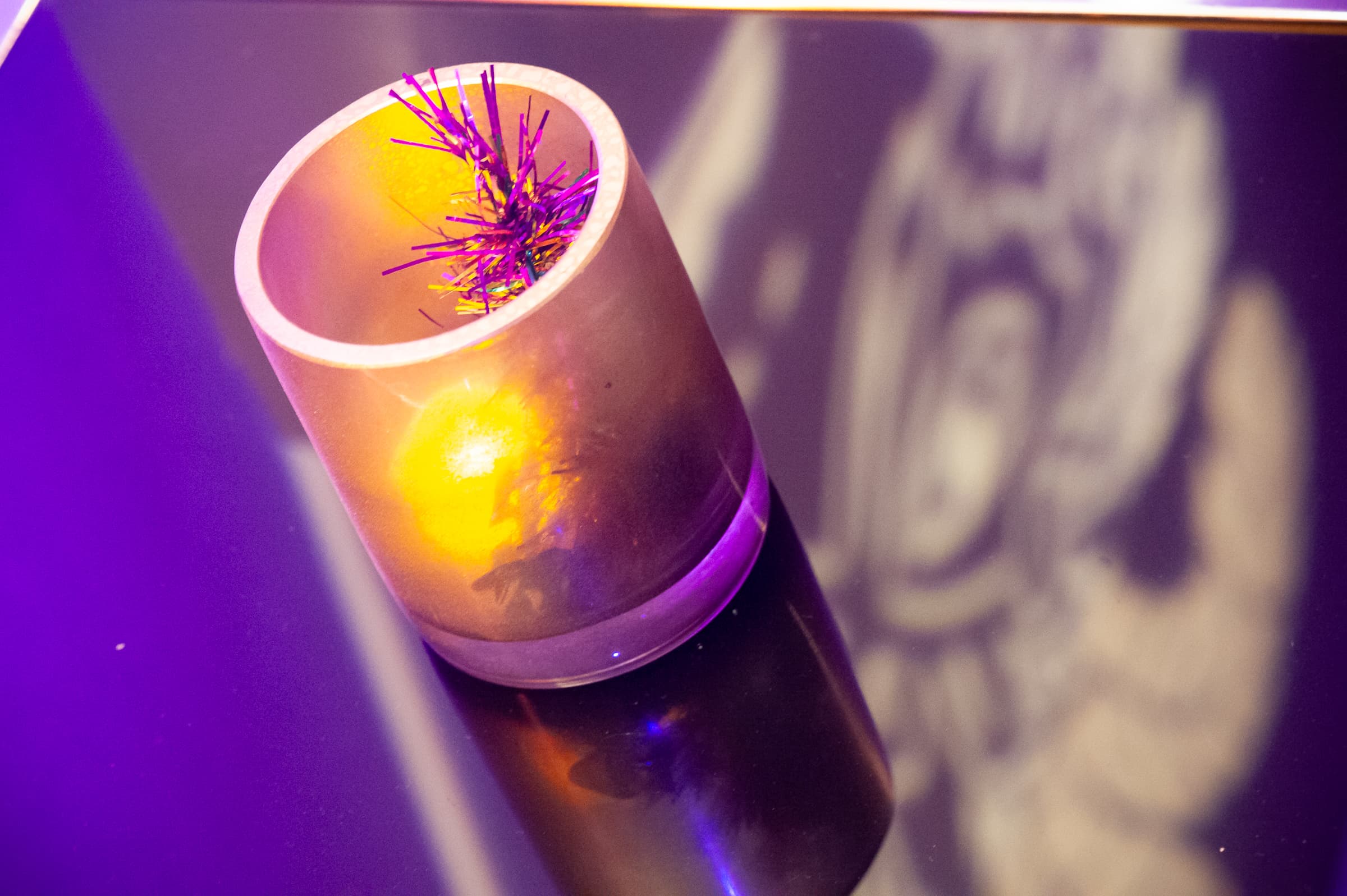 Candlelight and colored uplighting detail at a holiday party
