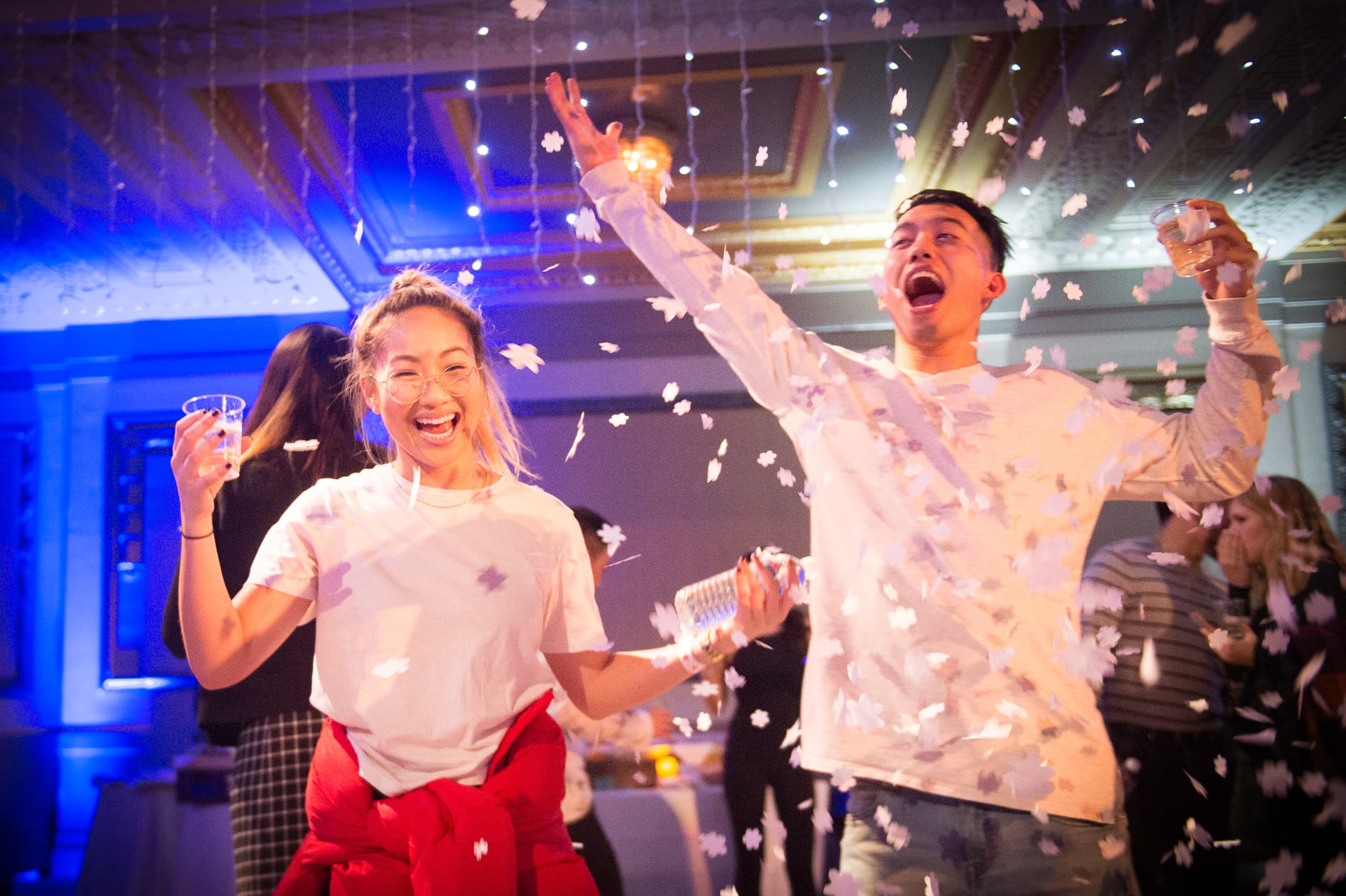 Guests celebrating with confetti at a corporate holiday party