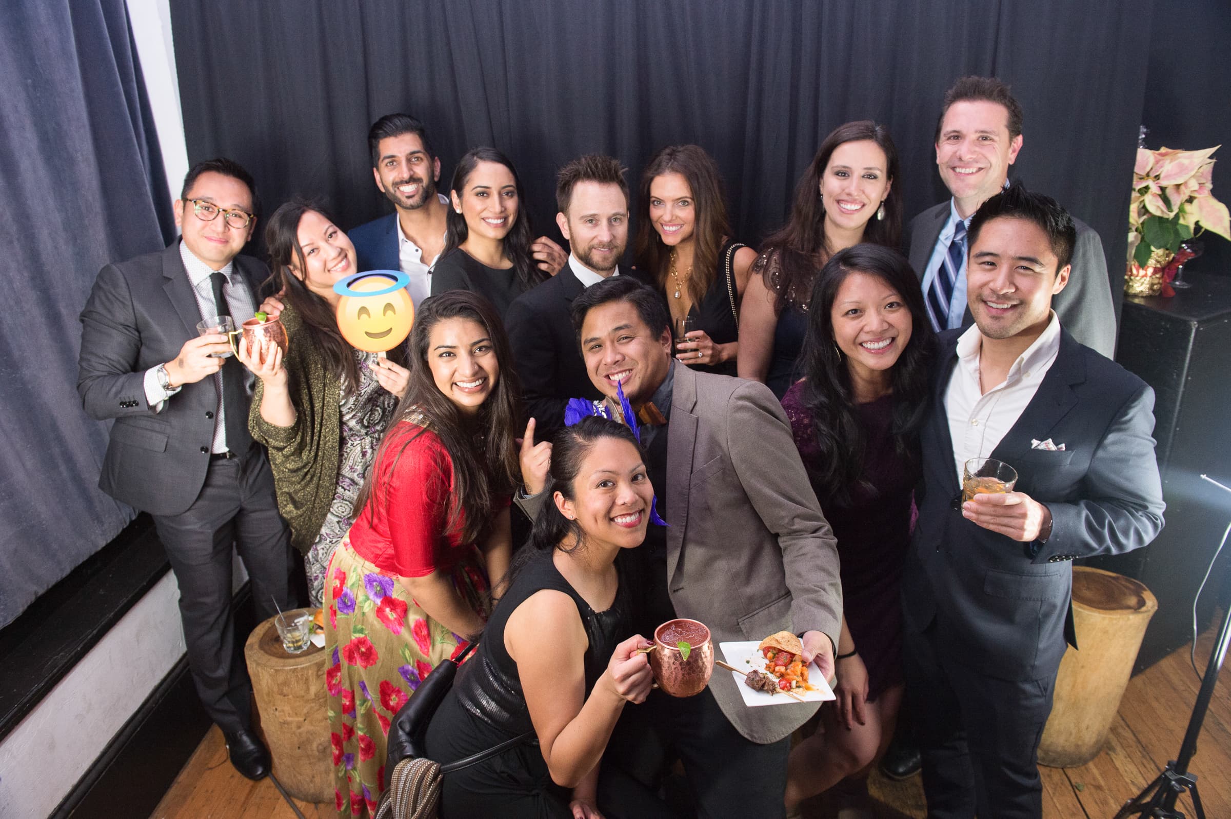 Colleagues gathered together with drinks at a company holiday party