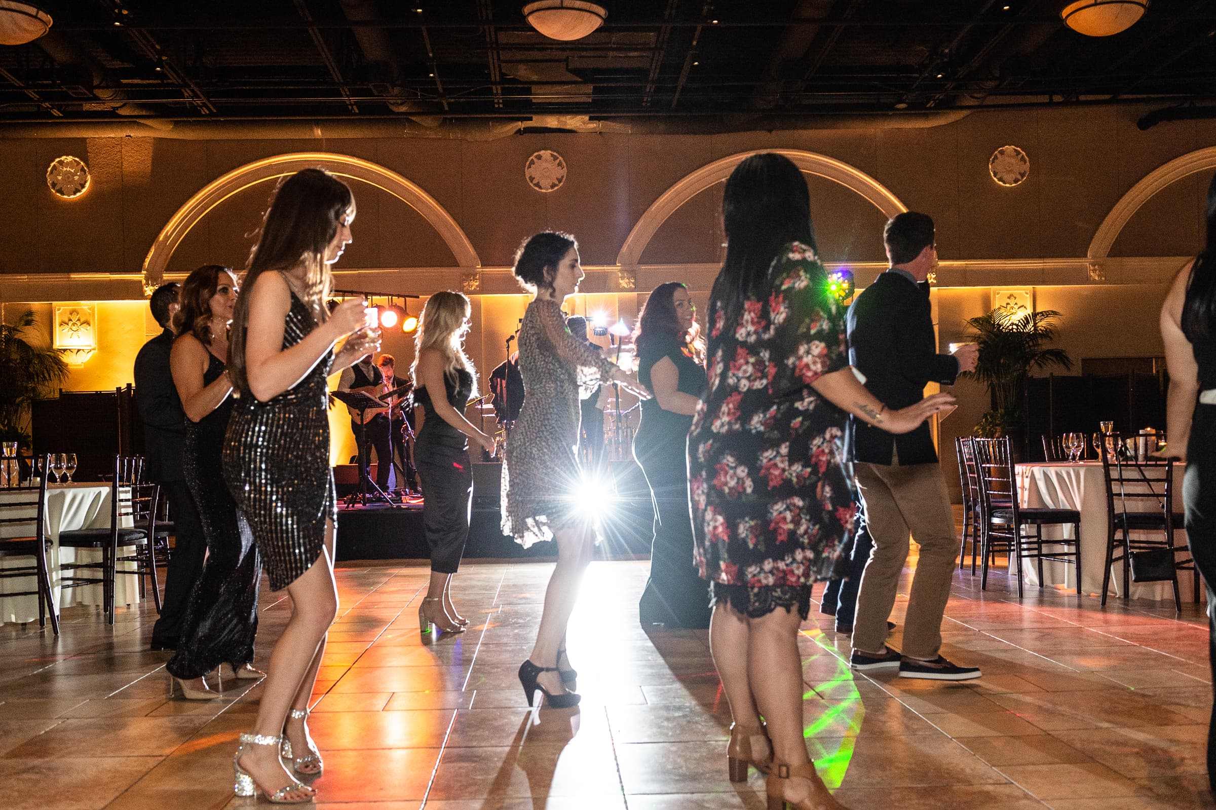 Guests dancing together on a busy holiday party dance floor