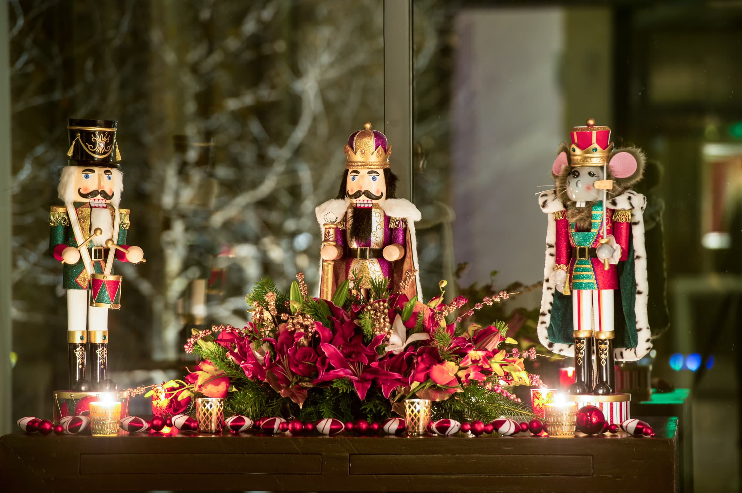Nutcracker figures and florals arranged as holiday party decor
