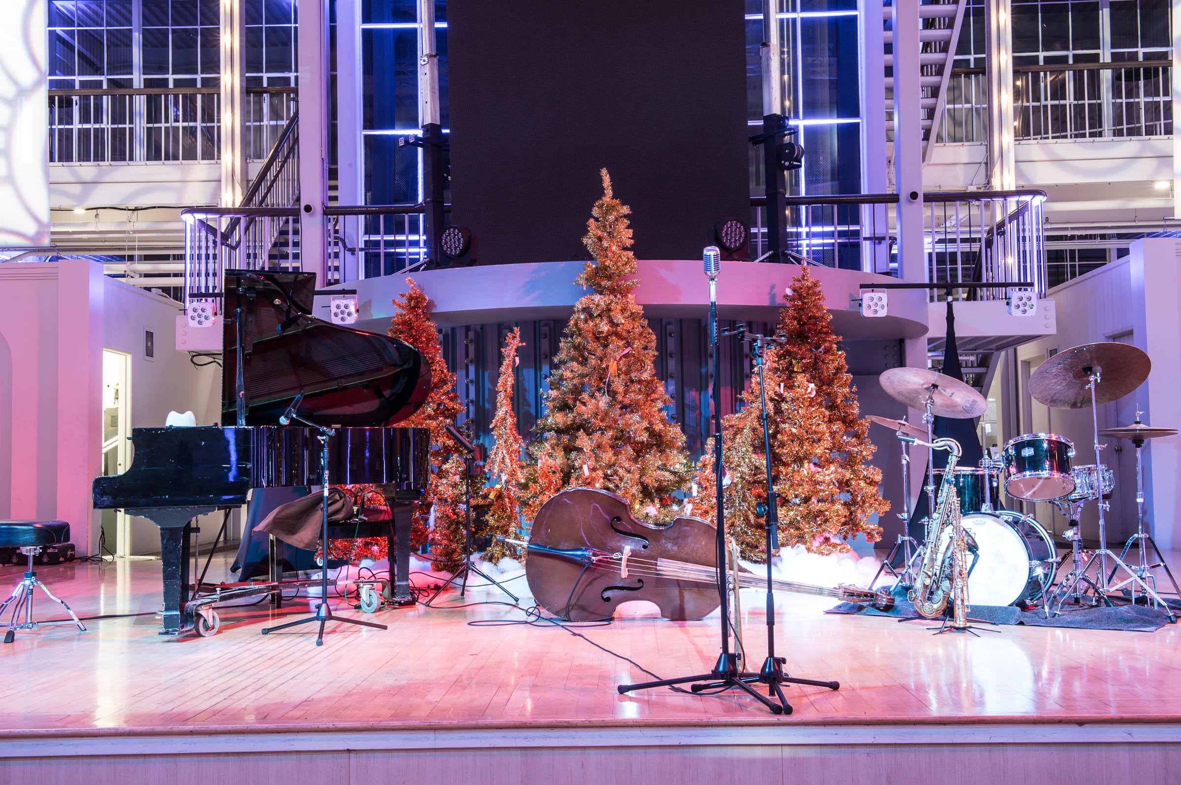 Stage with holiday trees and band equipment set before a company party