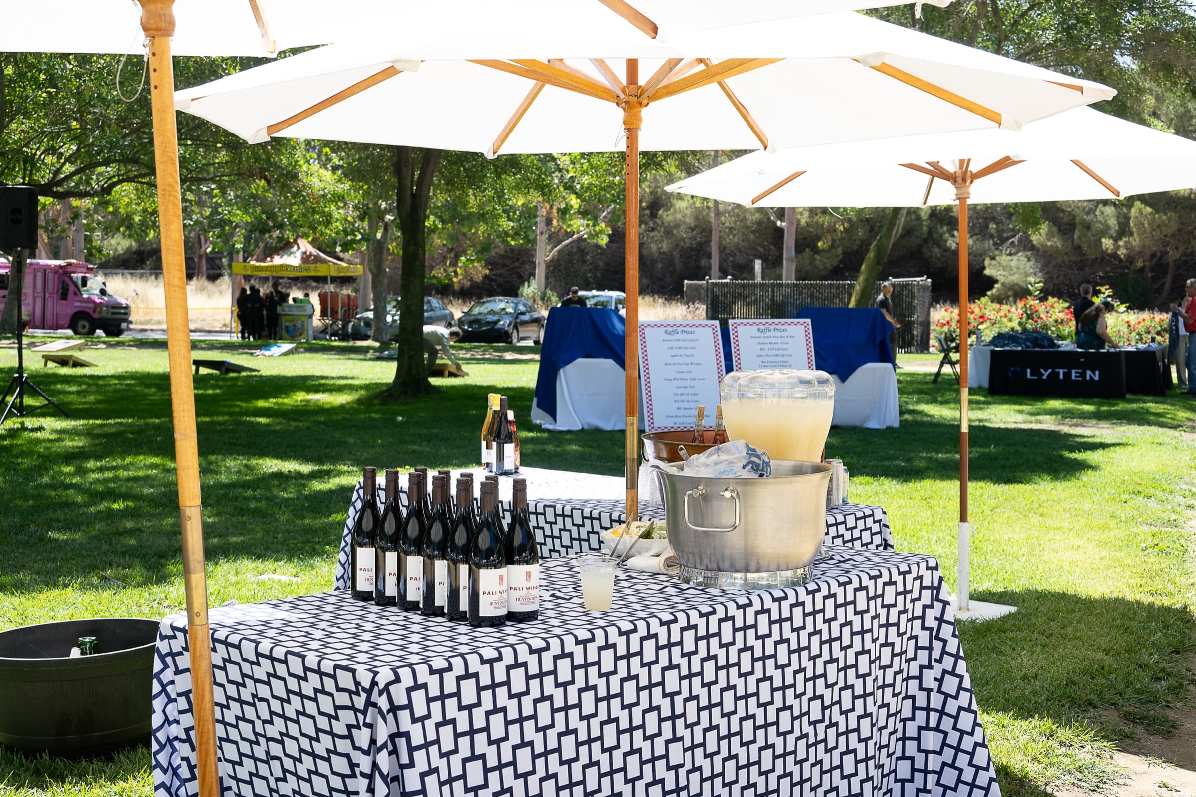 Outdoor bar set under umbrellas at a daytime company event