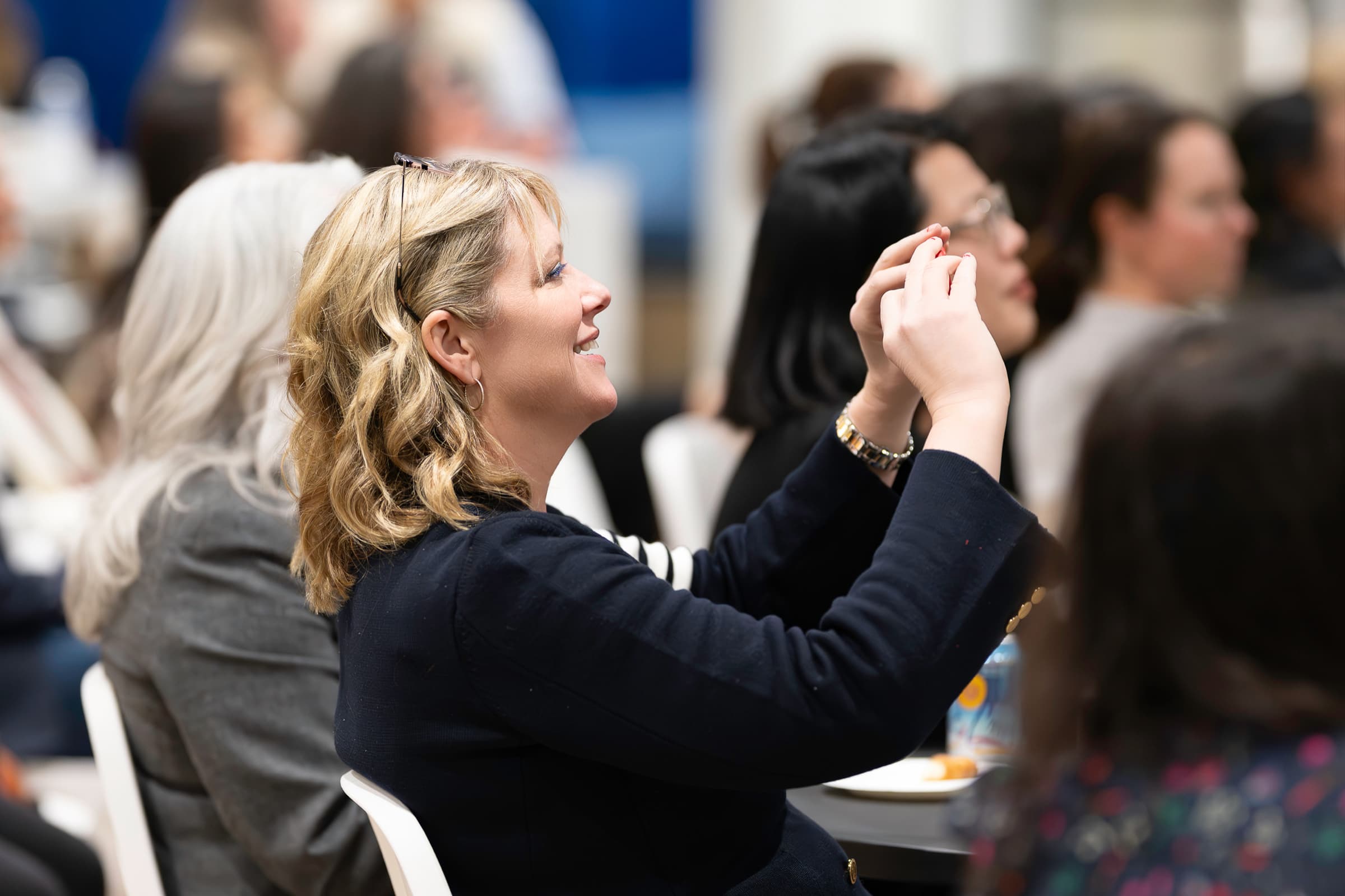 Attendee listening intently during a conference panel