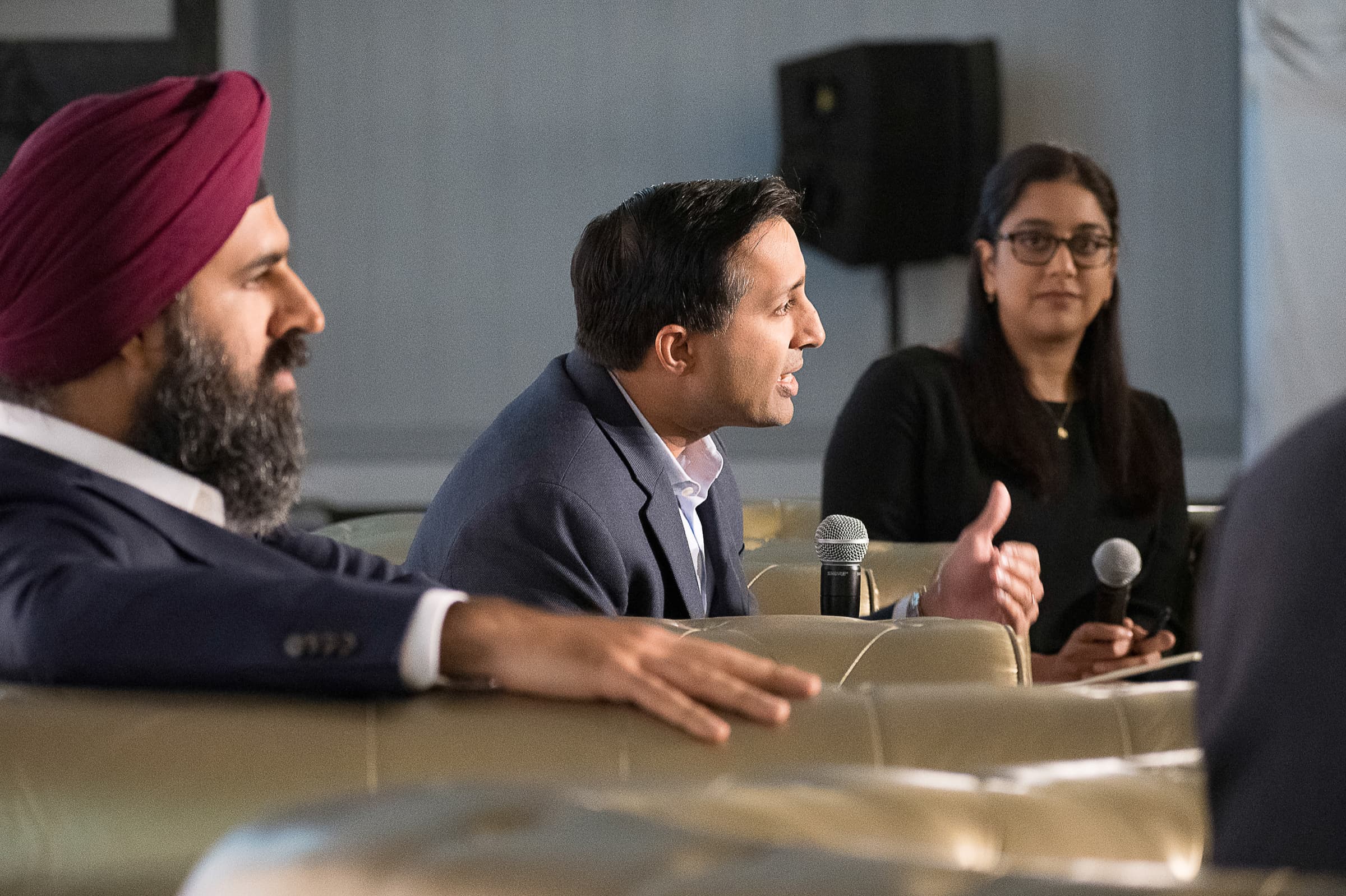Panelists seated at a head table during a moderated discussion