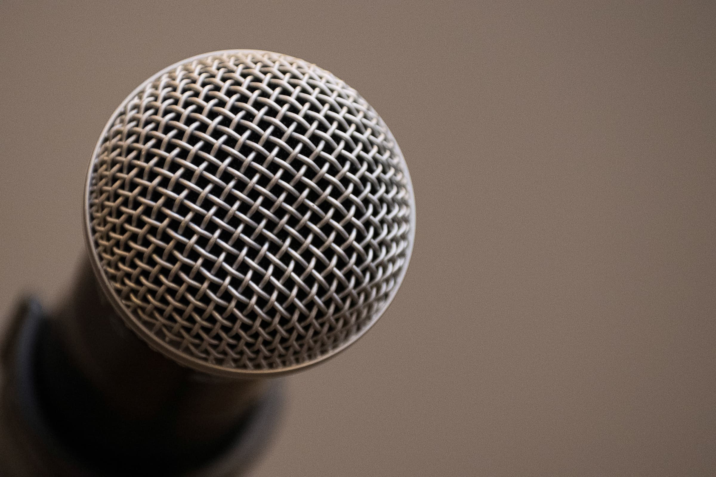 Handheld microphone photographed close before a panel session
