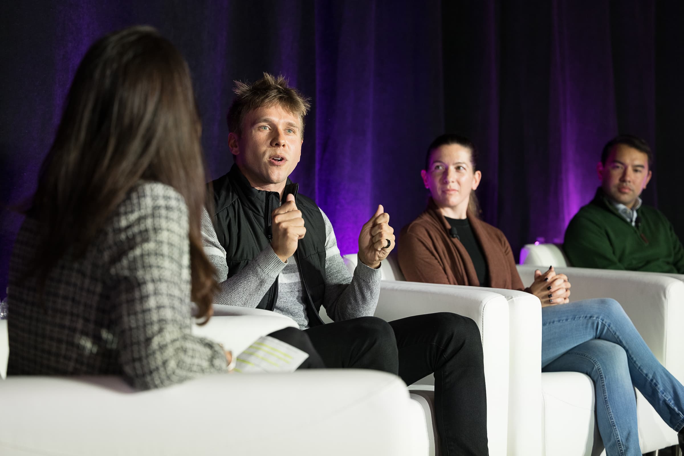 Panelist answering a question with a handheld microphone