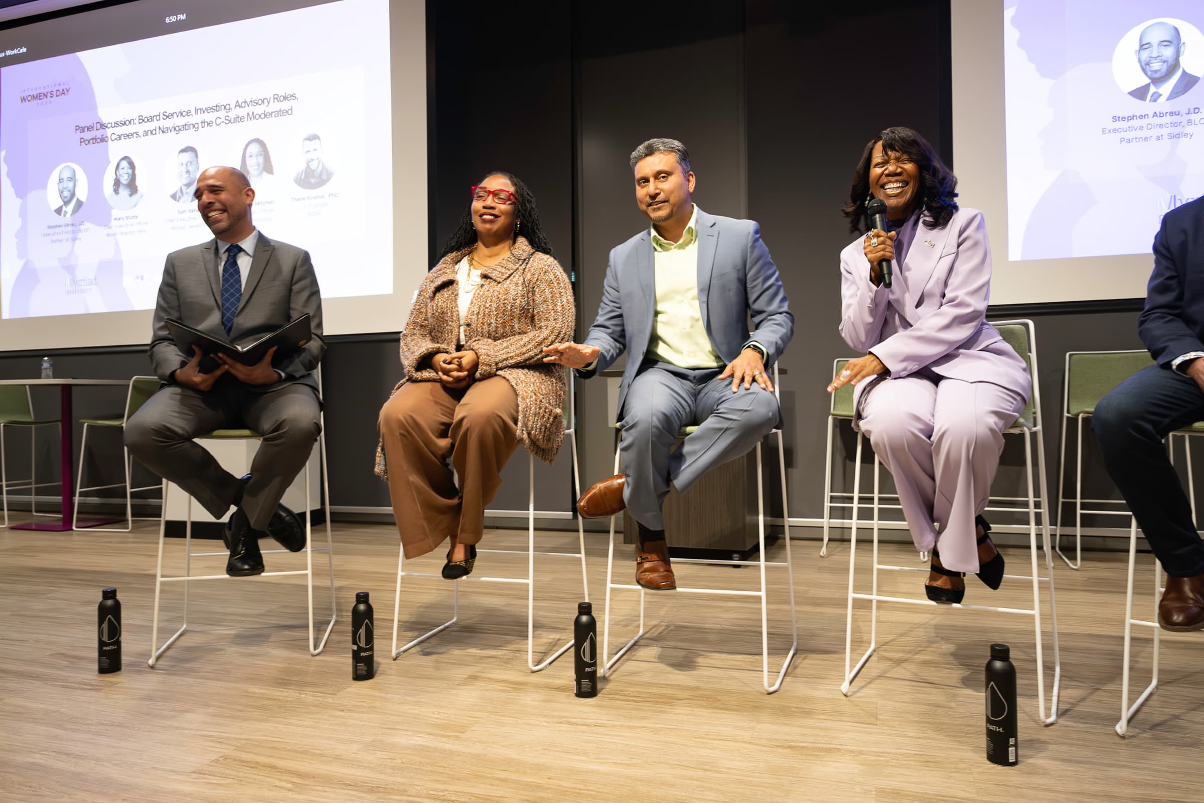 Panelists seated in discussion during a conference session