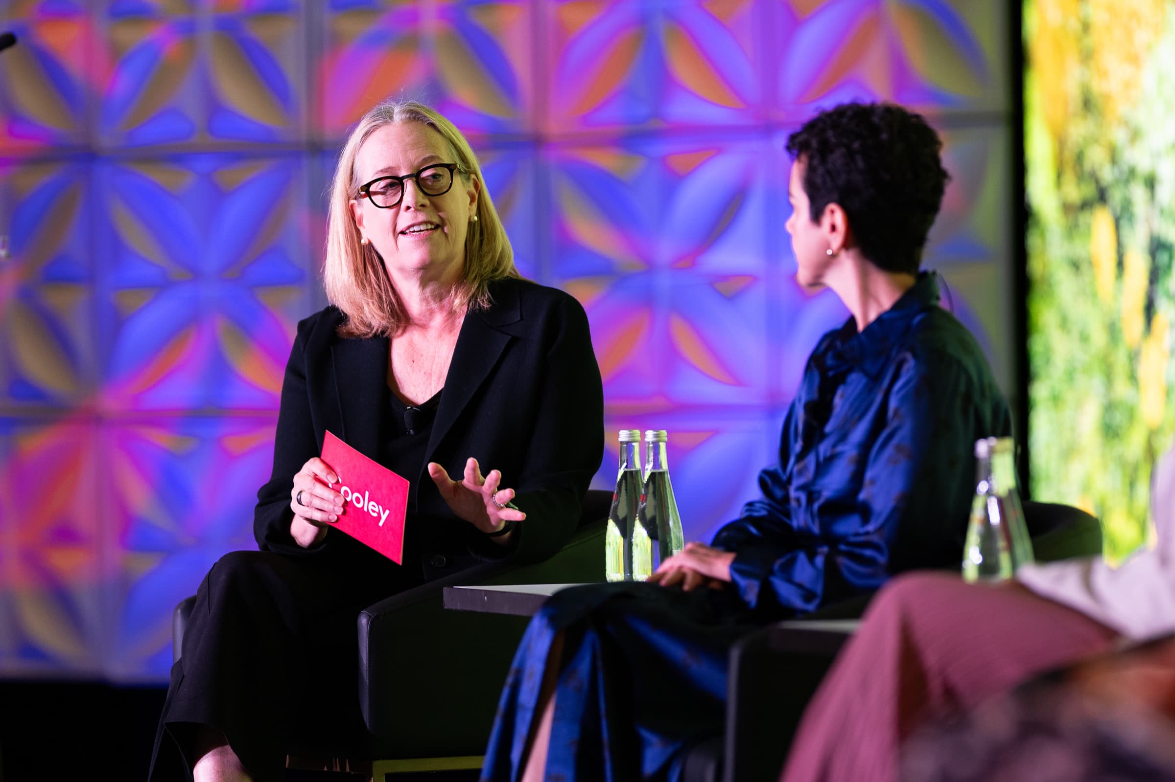Two speakers in conversation on stage during a session