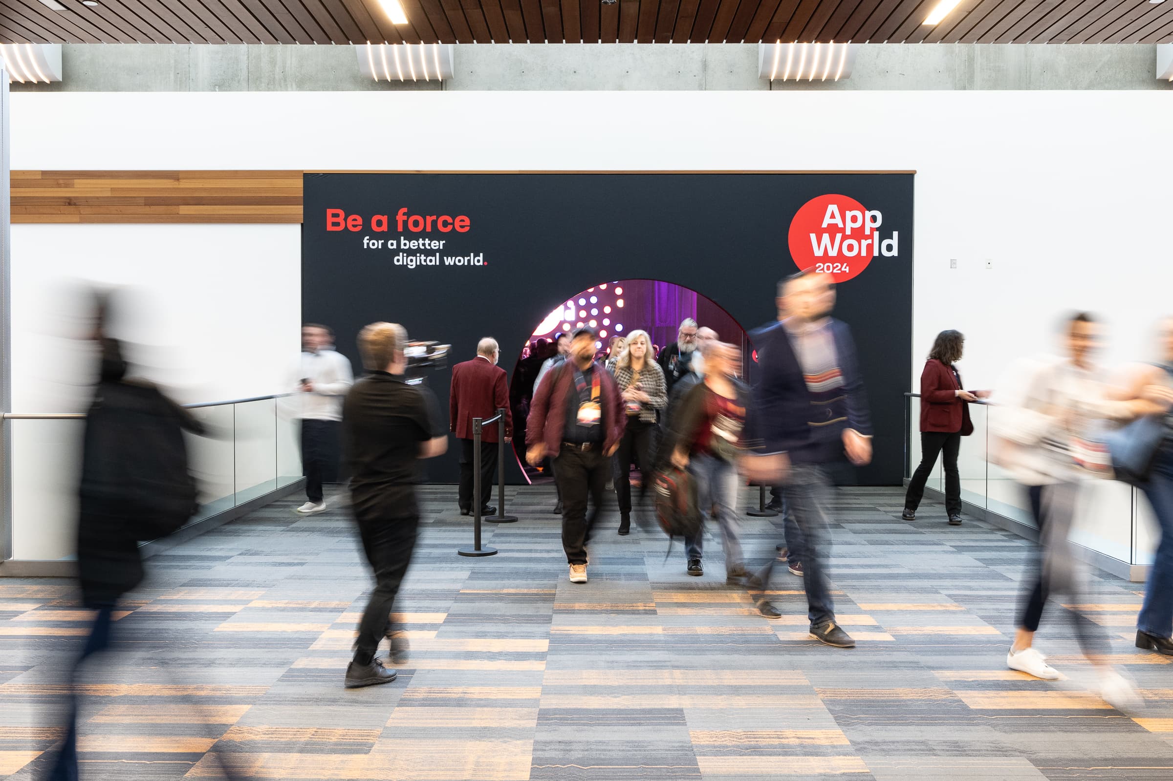 Attendees streaming into a conference keynote hall