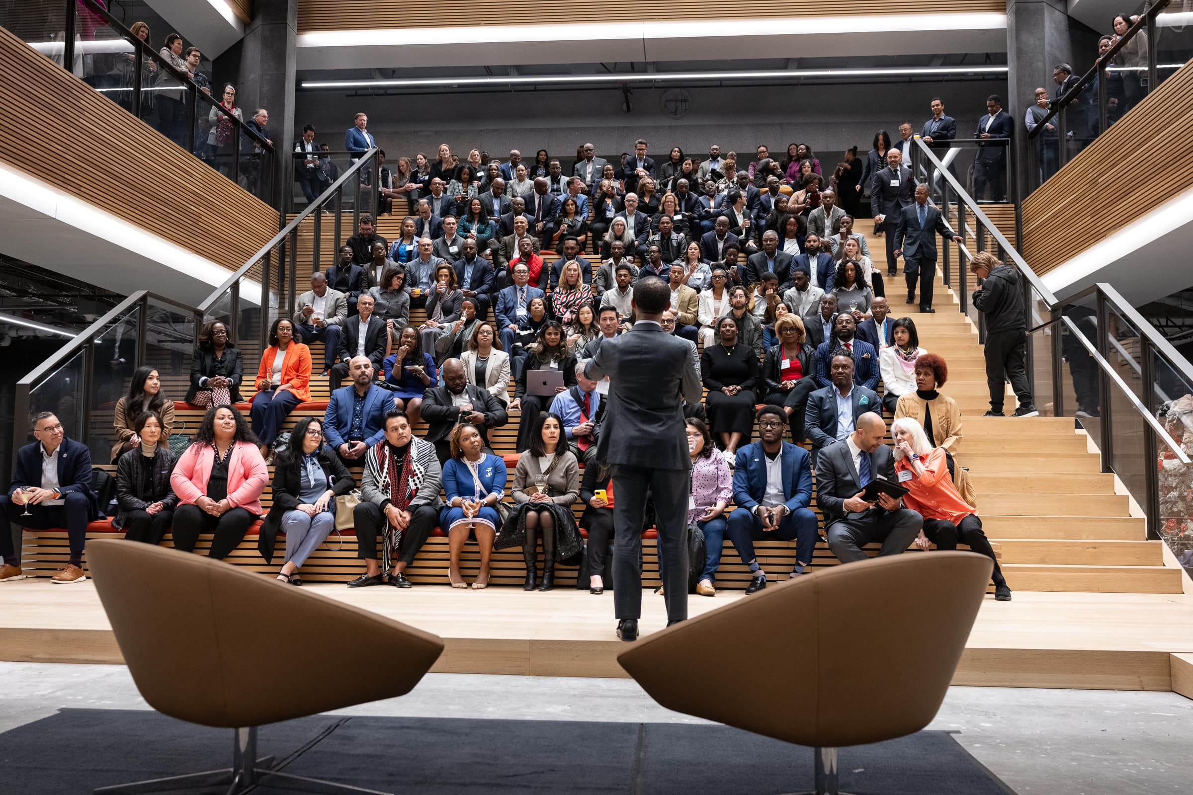 Executive presenting to an attentive audience in a San Francisco stadium-seating venue