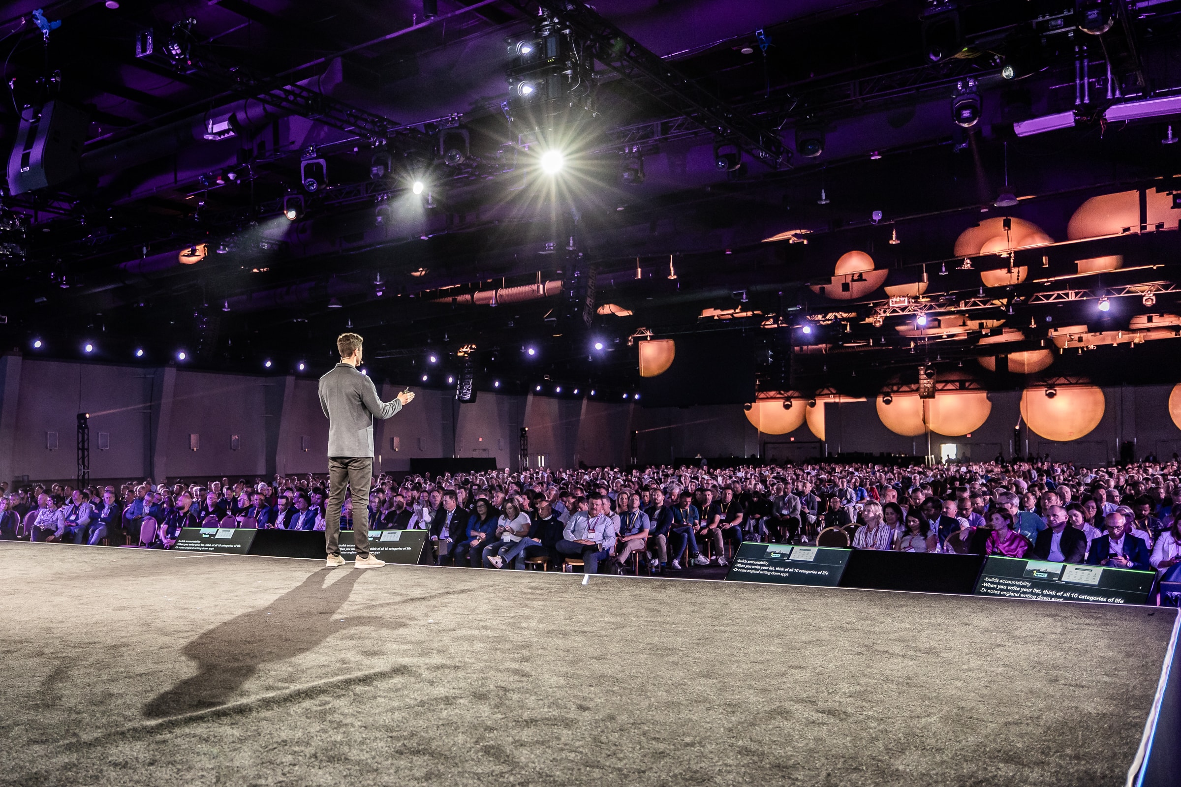 Keynote speaker presenting to a large seated conference audience
