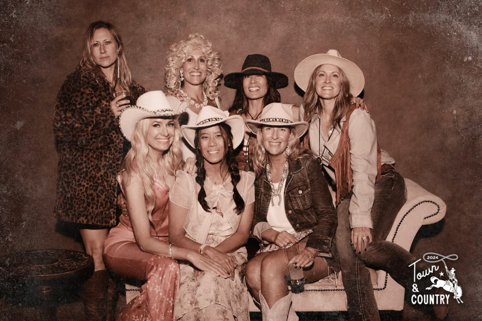 Vintage-style sepia group portrait with themed event branding in the corner