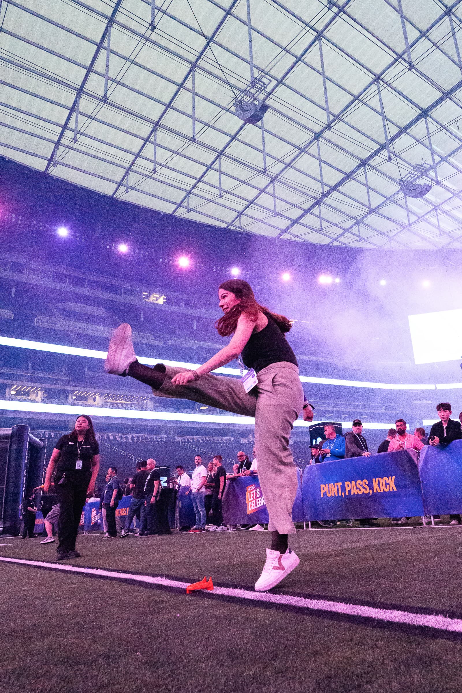 Individual performer in athletic wear executing movement in stadium venue