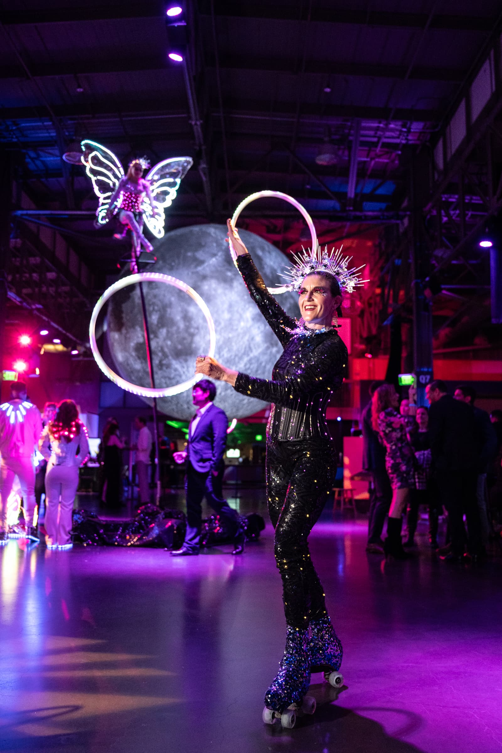 Bubble artist performing under magenta lighting at an evening showcase