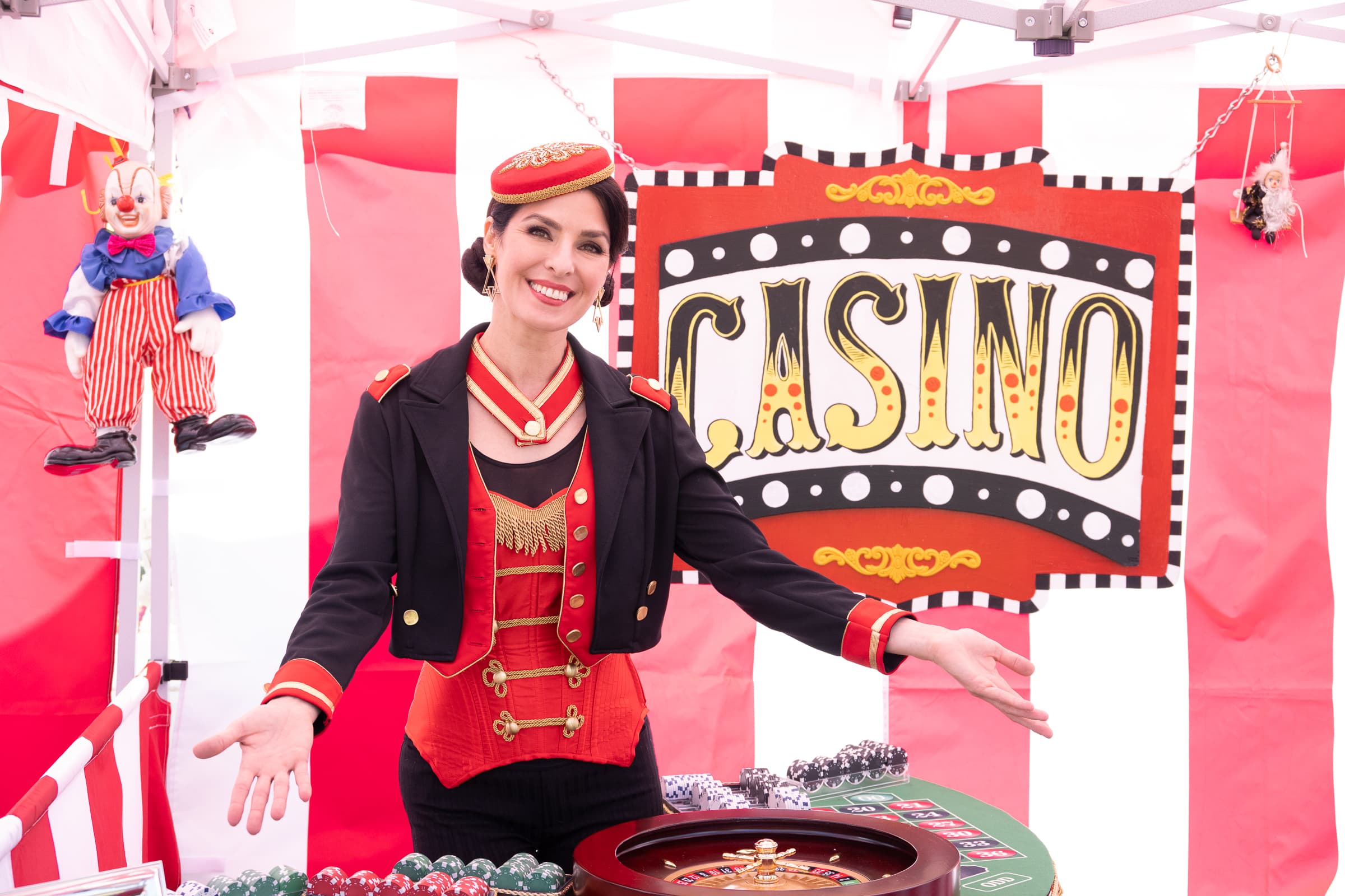 Costumed performer welcoming guests beside a vintage casino backdrop