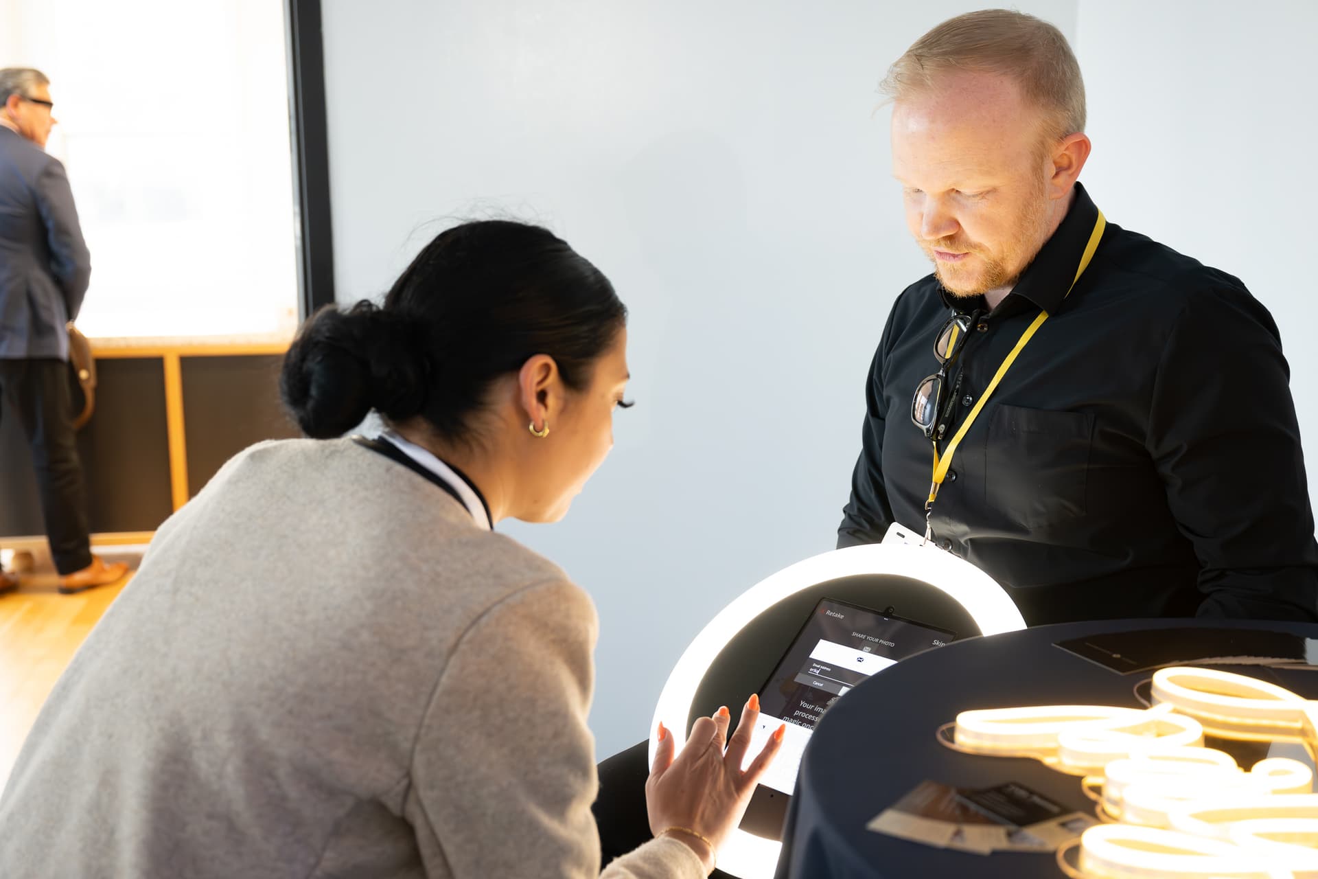 Two operators running a lit content-capture station at an event