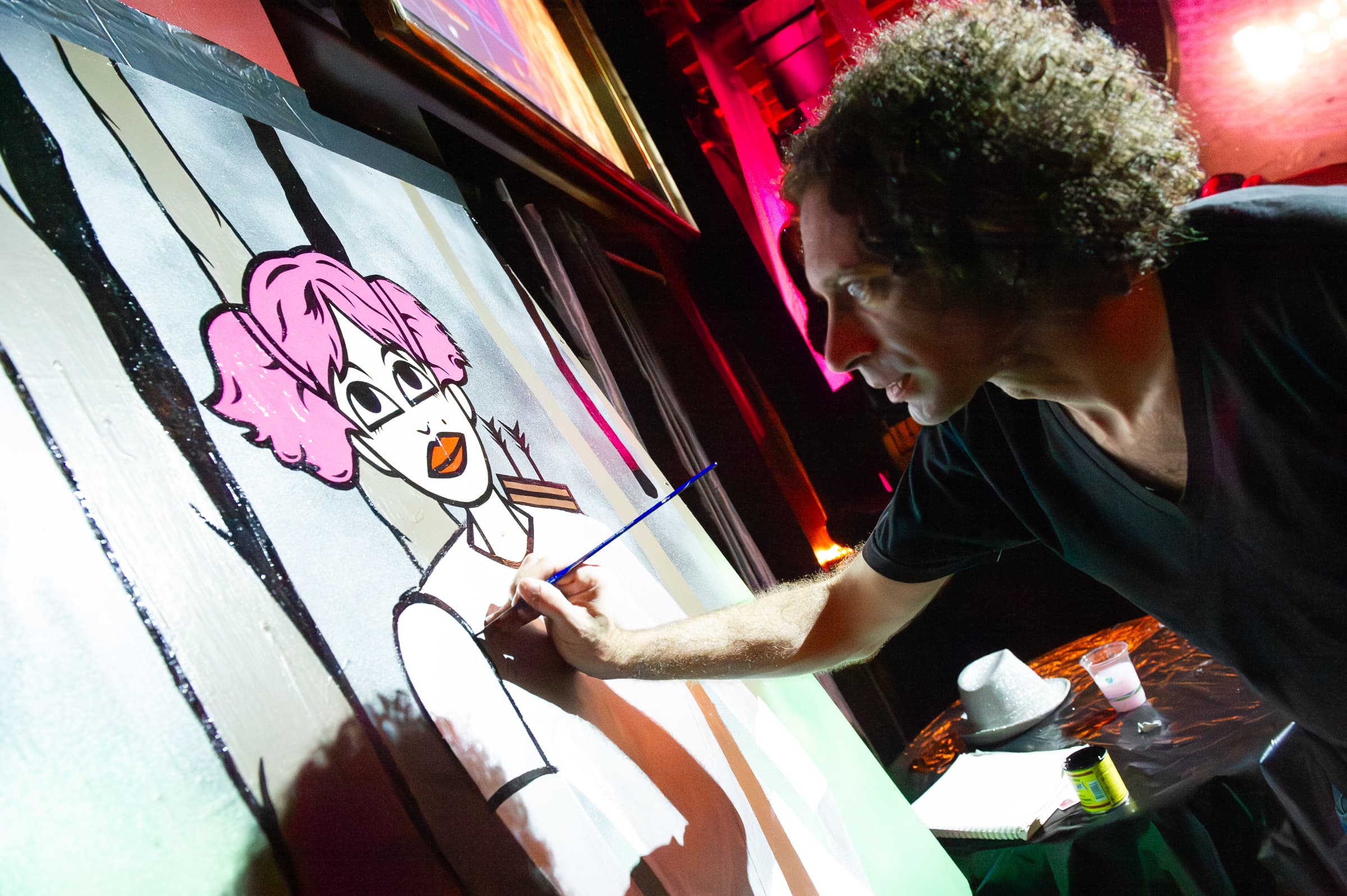 Digital caricature artist drawing a guest on a large illuminated tablet