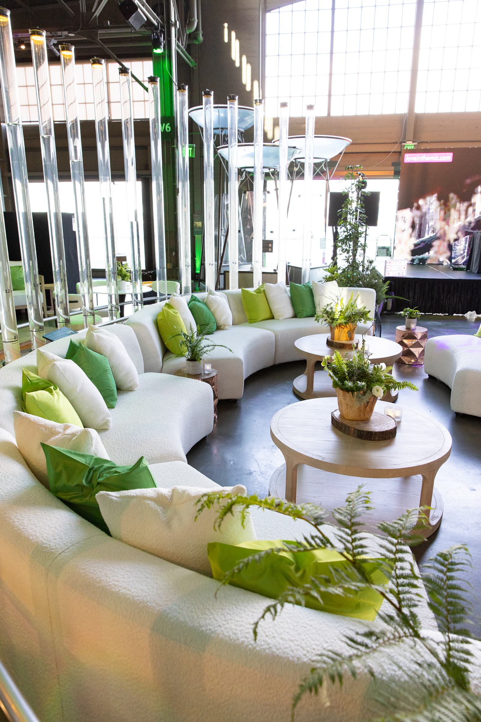 Curved white lounge furniture staged in a circular seating vignette