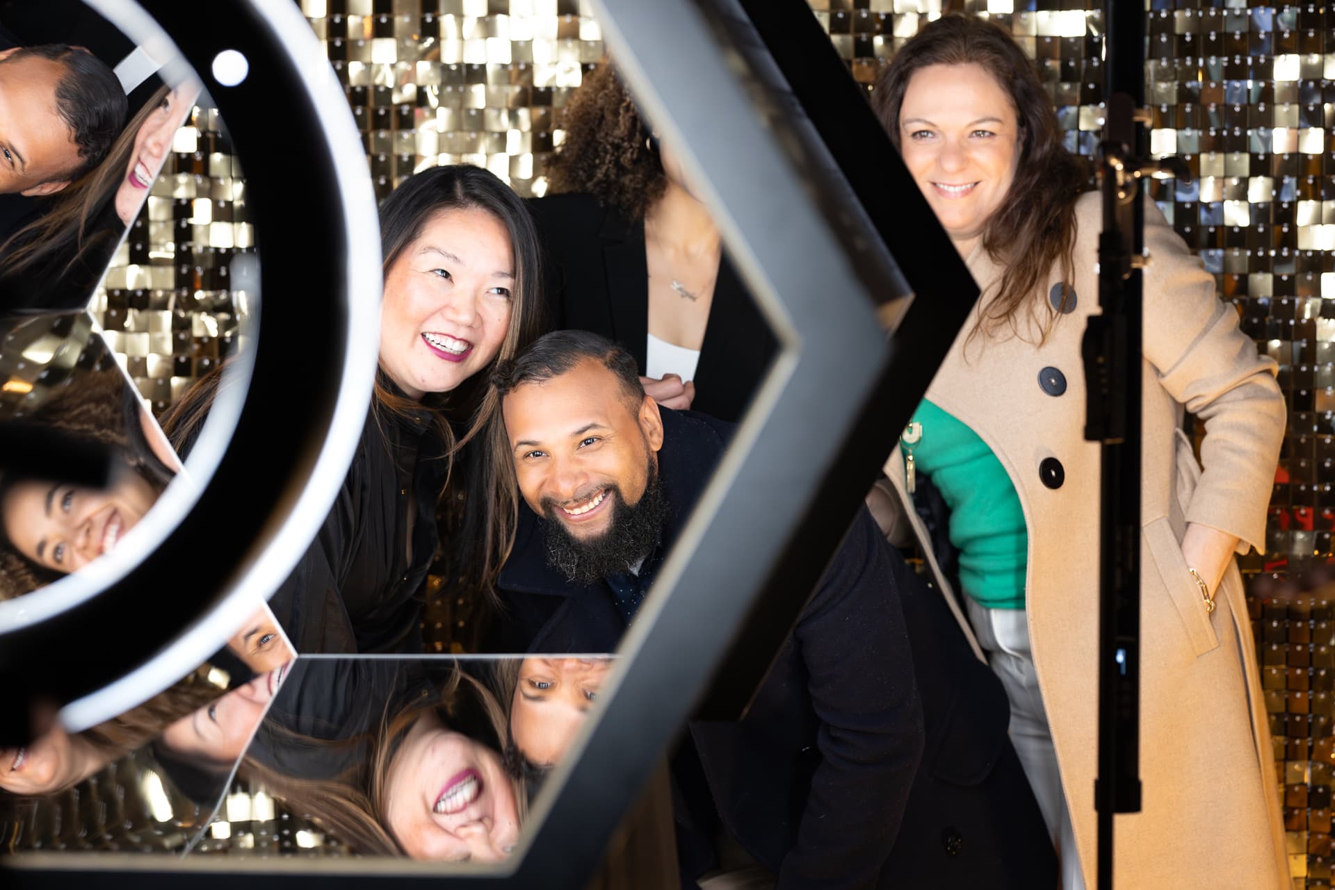 Guests laughing together at an interactive photo mirror
