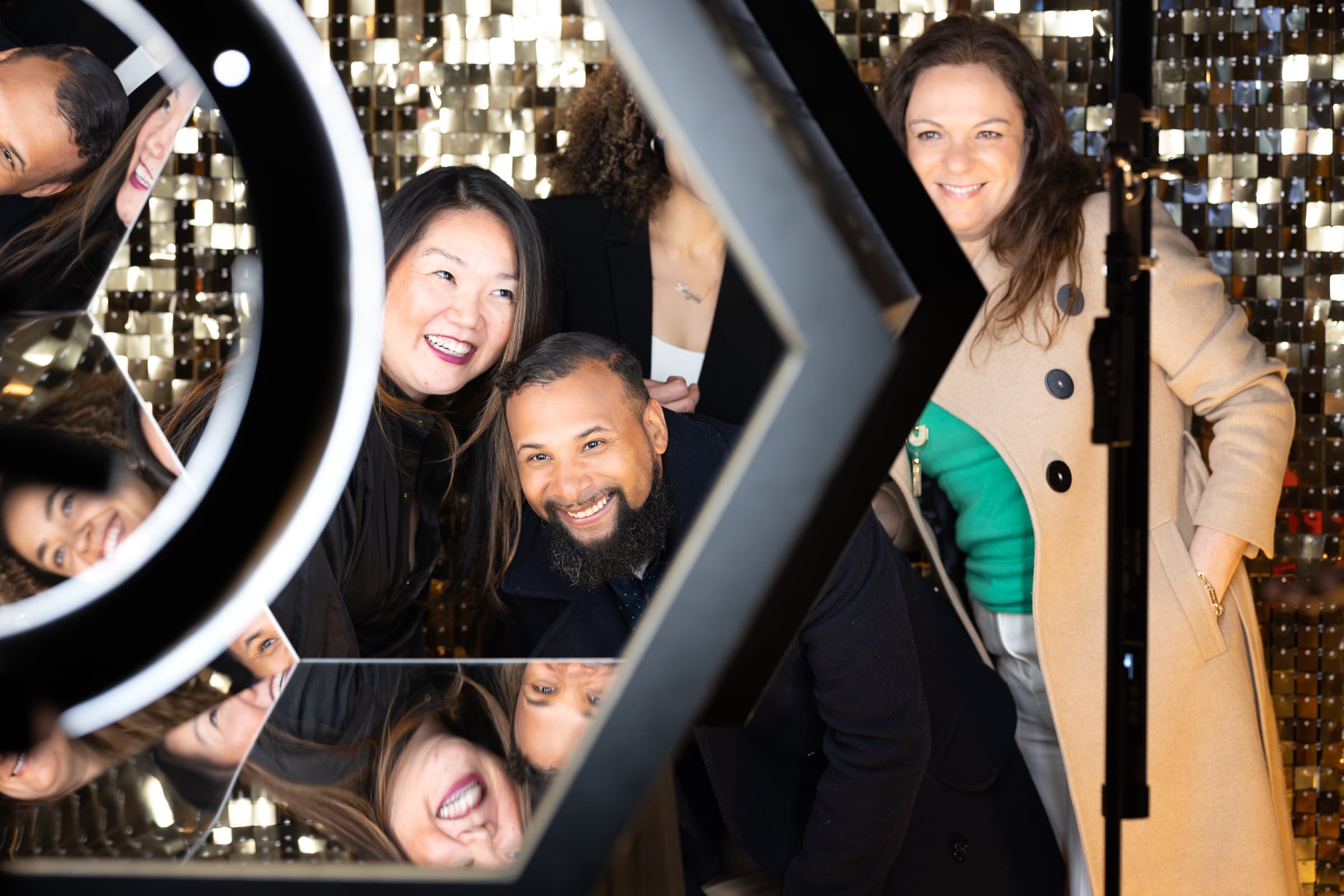 Guests laughing together at an interactive photo mirror