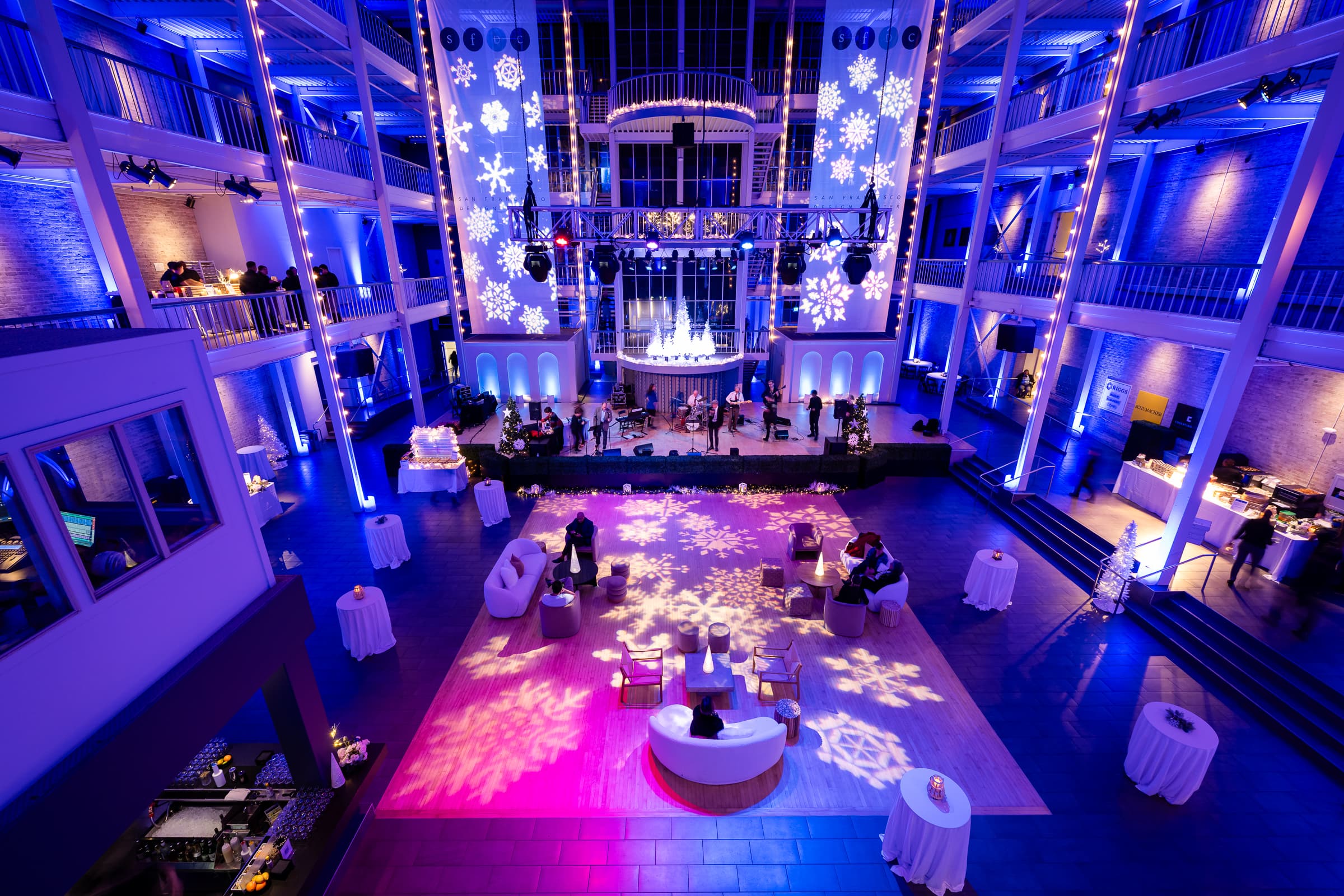 Ballroom washed in blue light with snowflake patterns projected across the dance floor