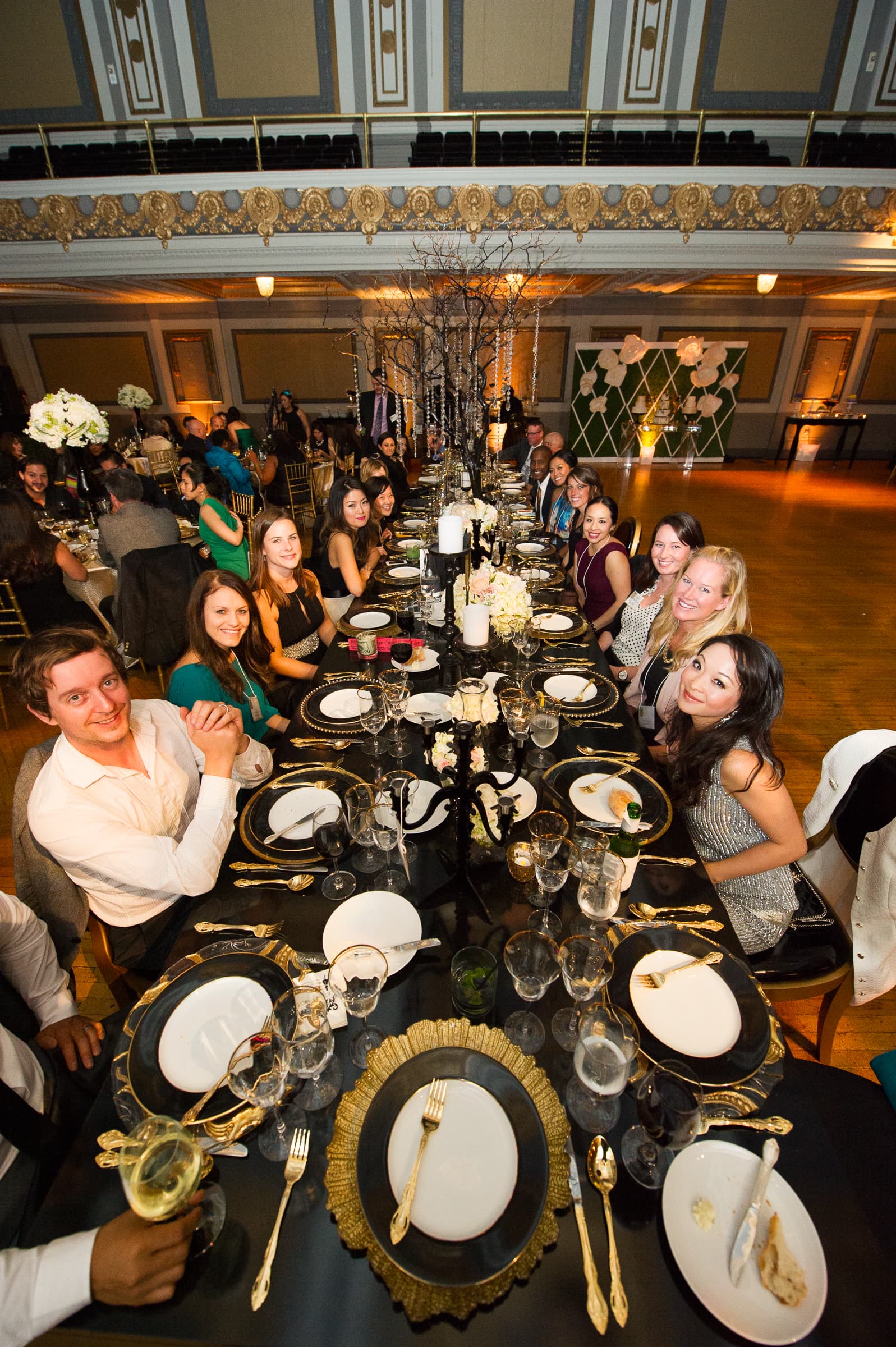 Overhead view of a banquet table dressed with drums and layered decor