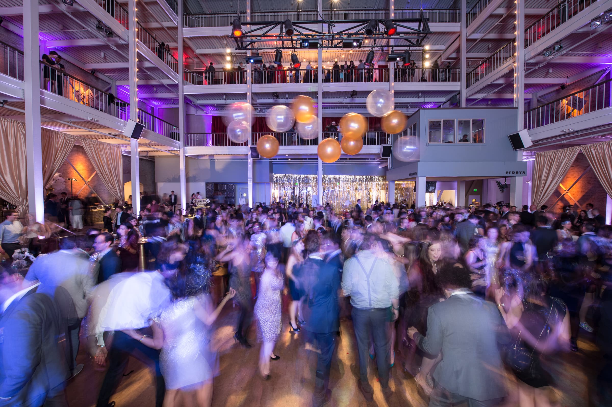 Packed dance floor photographed from above with motion blur