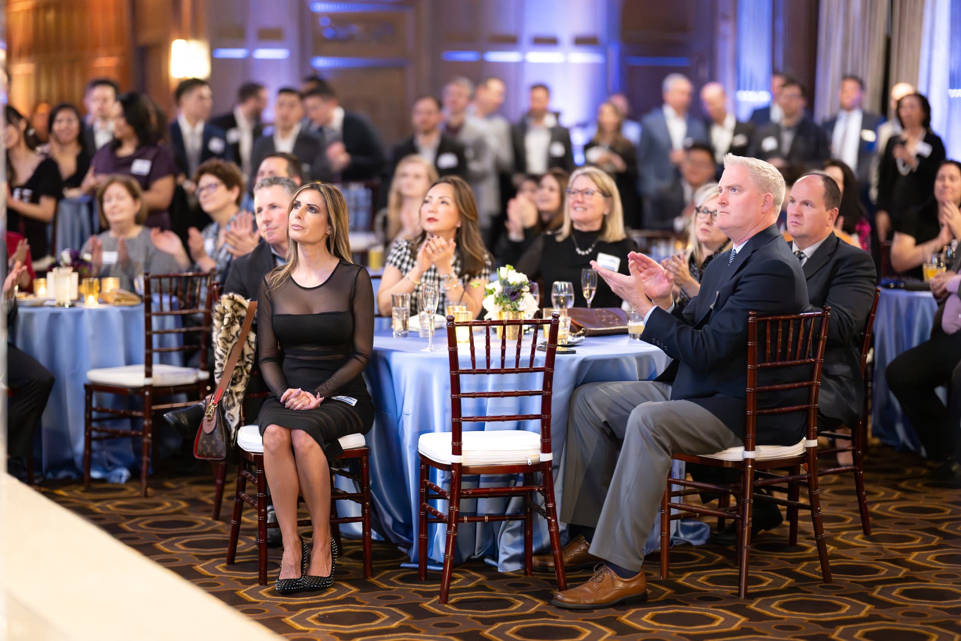 Seated guests applauding at banquet rounds during an awards programme