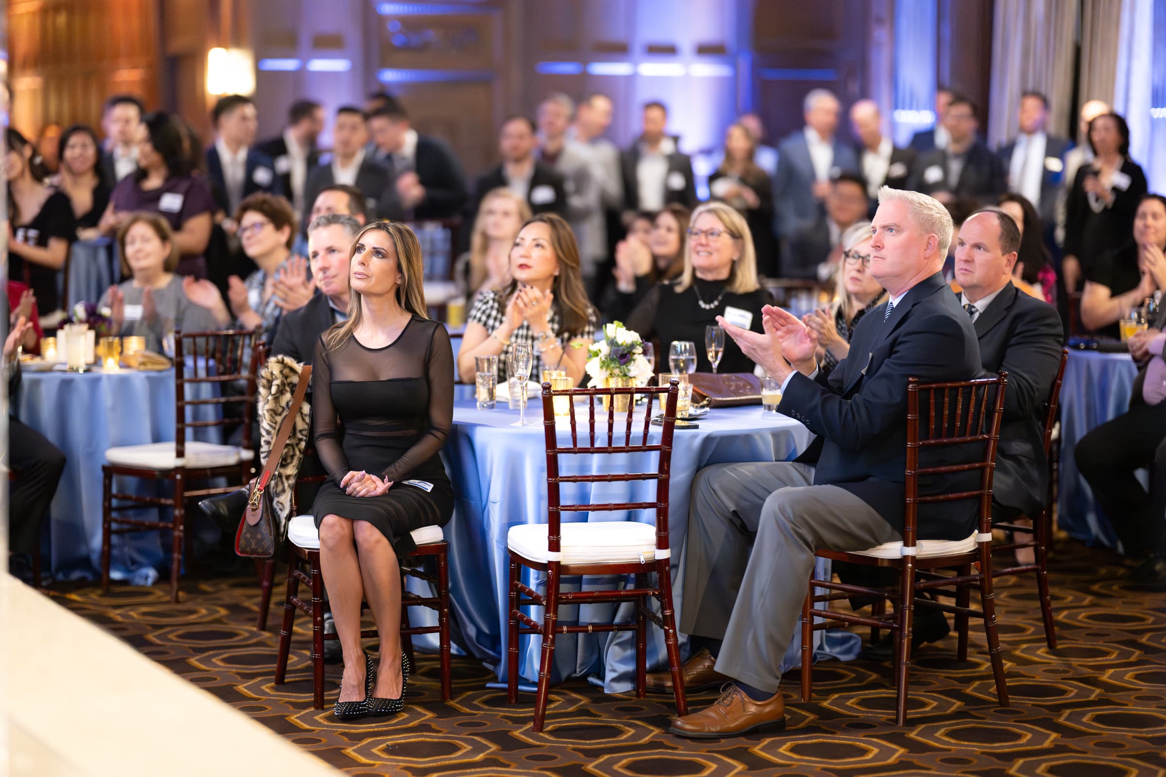 Seated guests applauding at banquet rounds during an awards programme