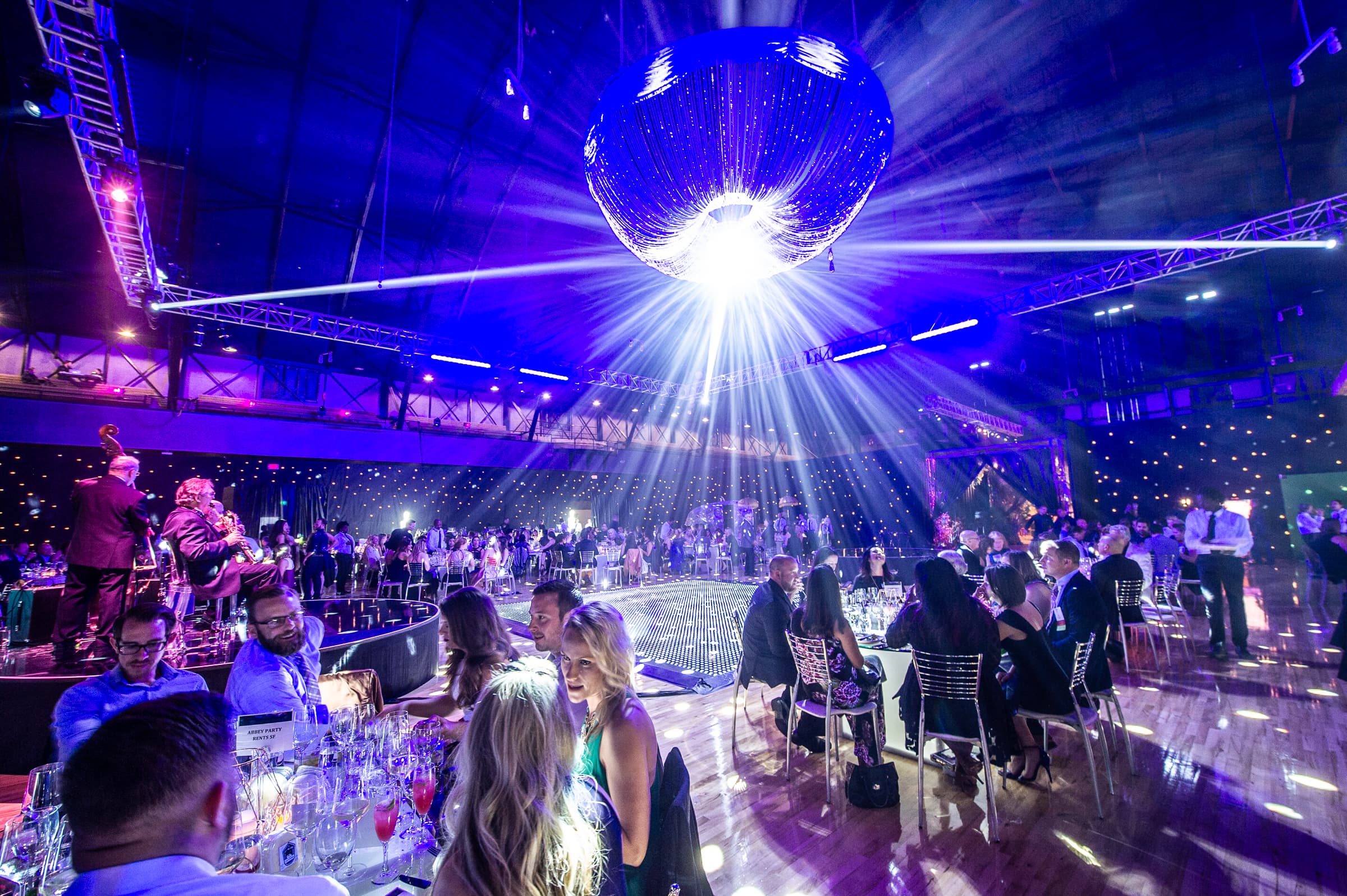 Ballroom seen from above with a mirror ball scattering light across the room