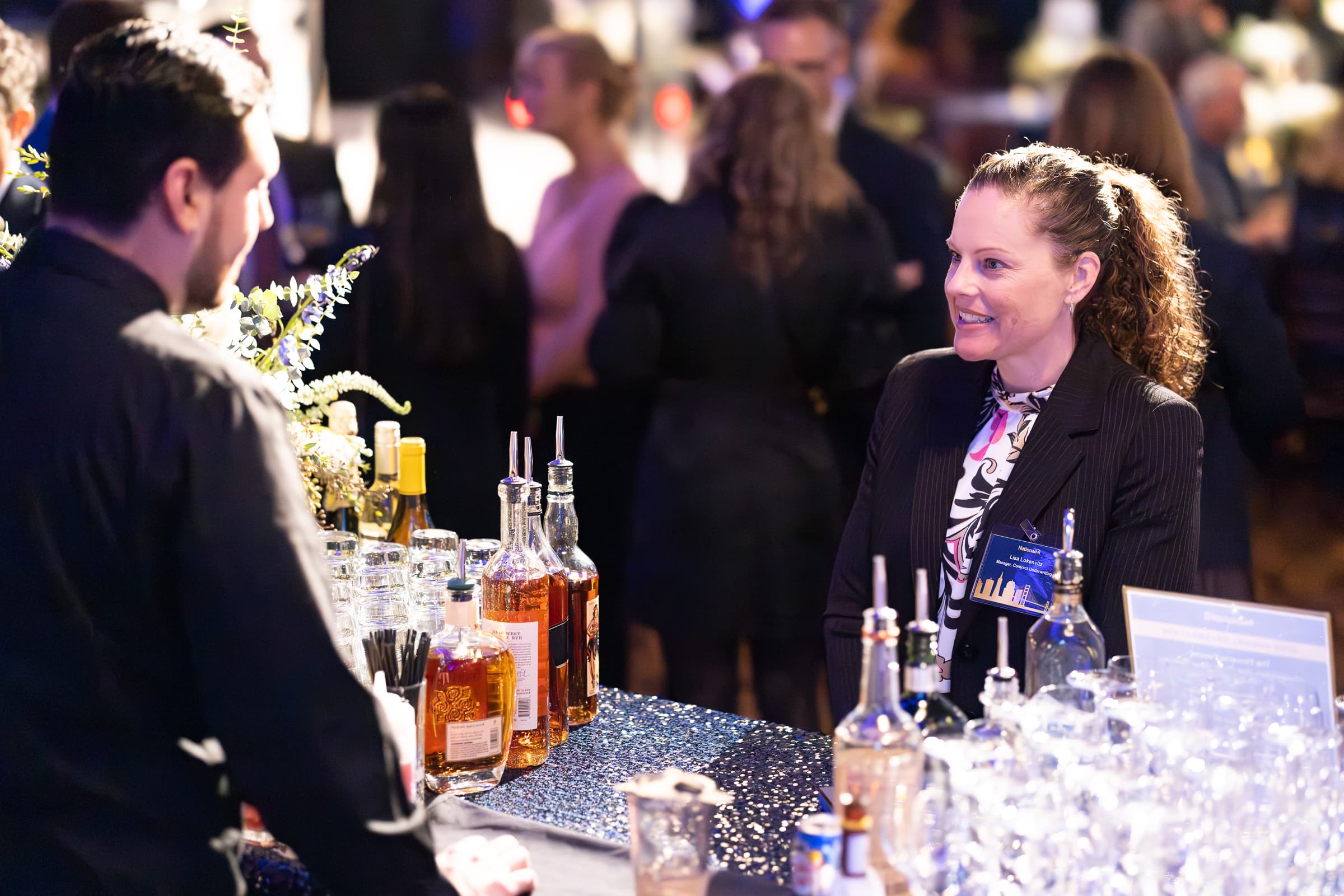 Guests talking at the bar during a black-tie reception