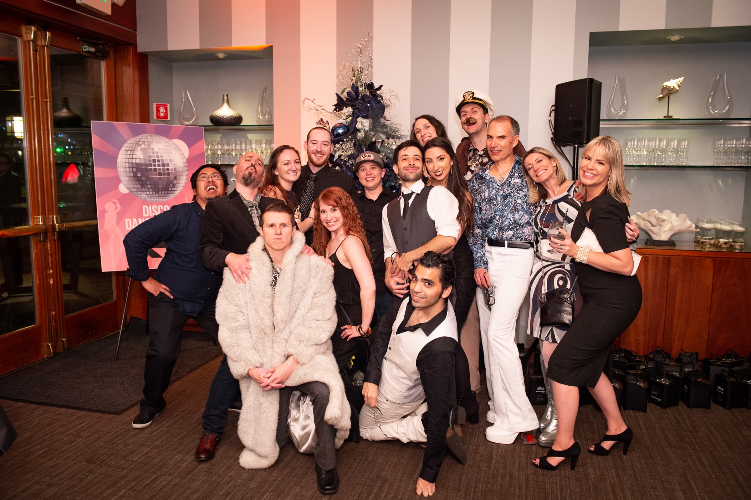 Large group of guests posed together with costume props