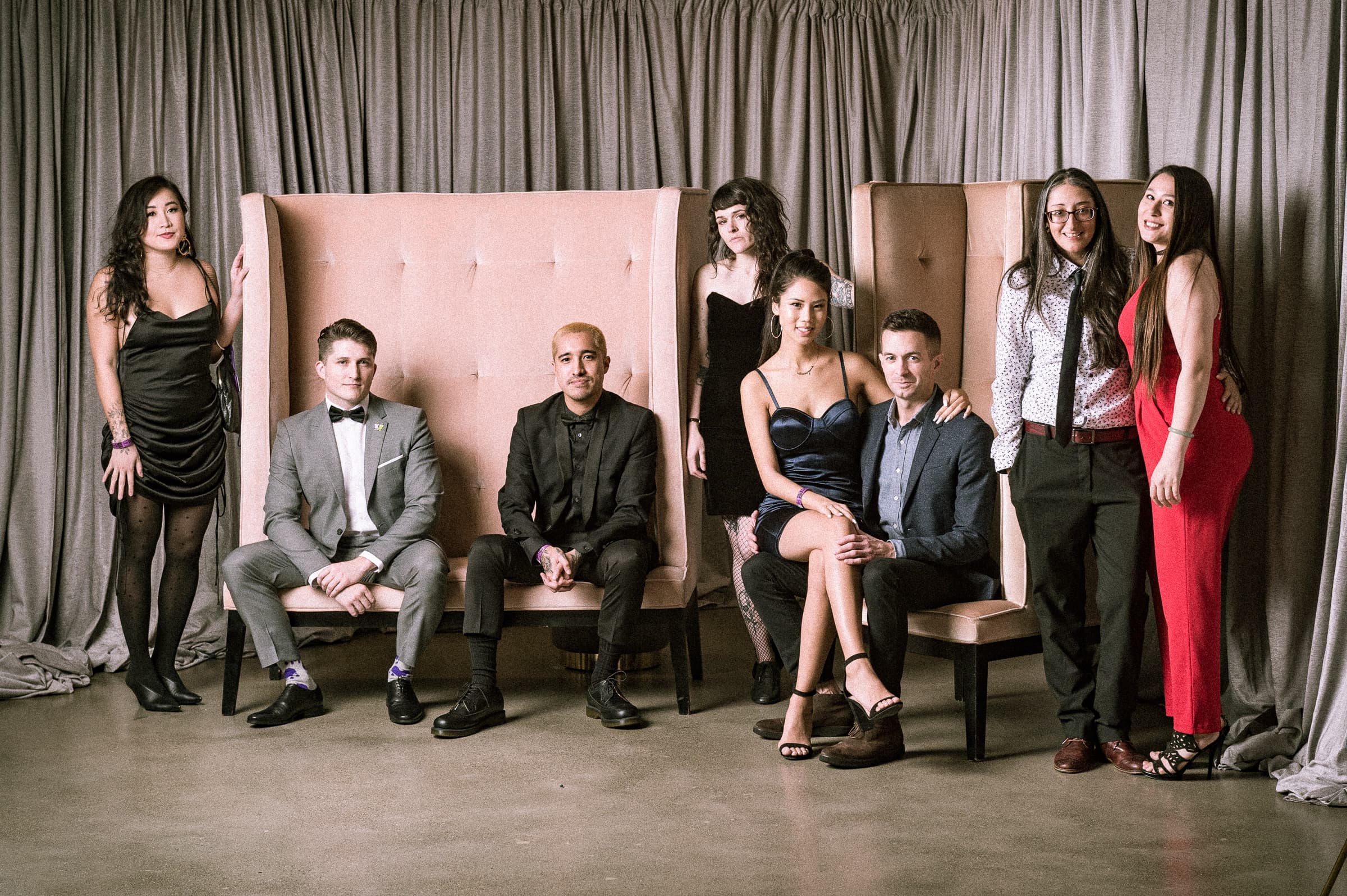 Eight guests arranged across a styled portrait vignette