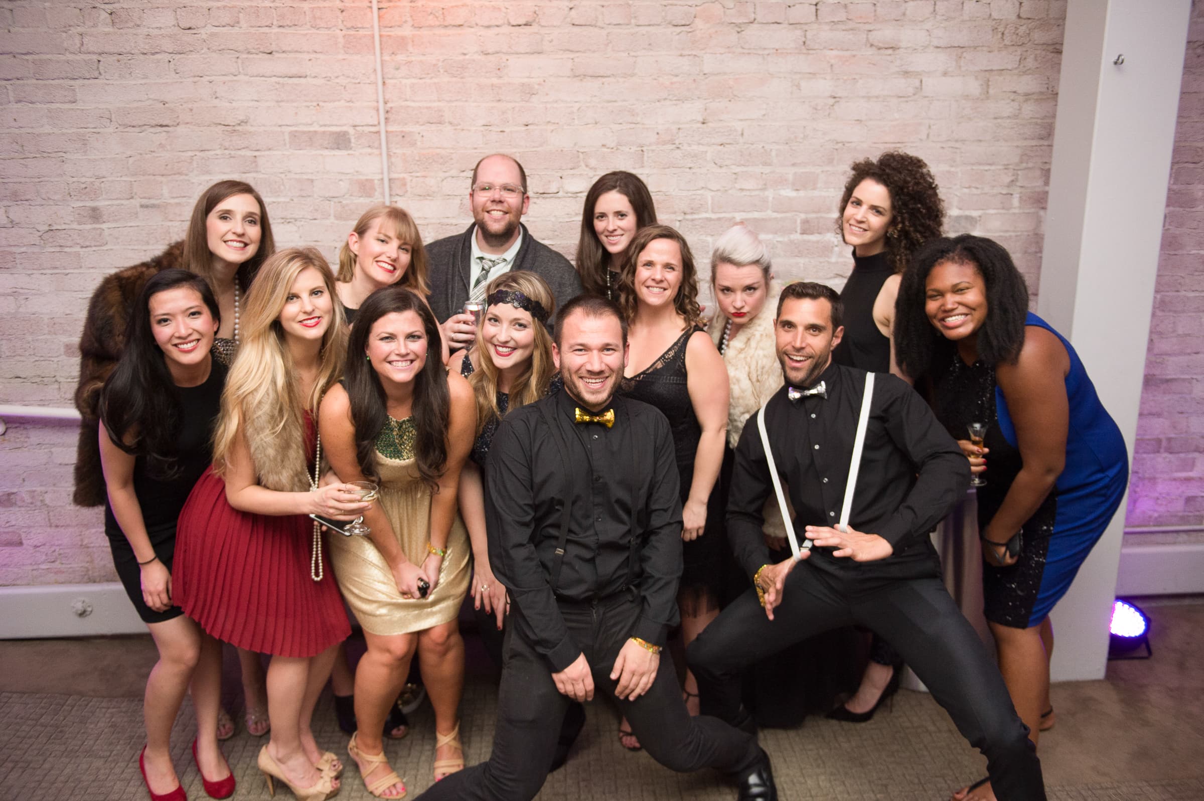 Guests crowded together with props for a group photograph