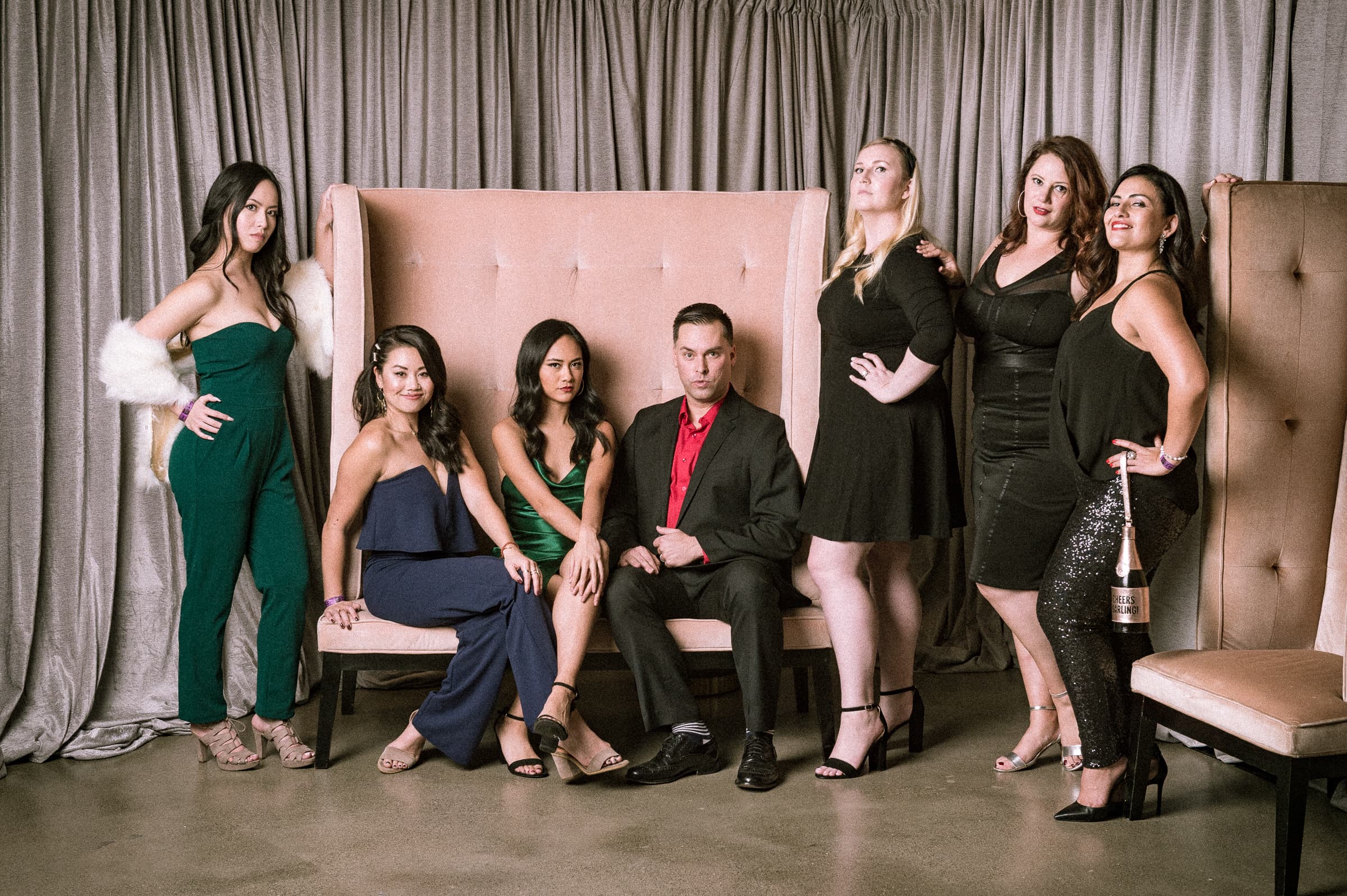 Ten guests photographed together across a styled settee vignette