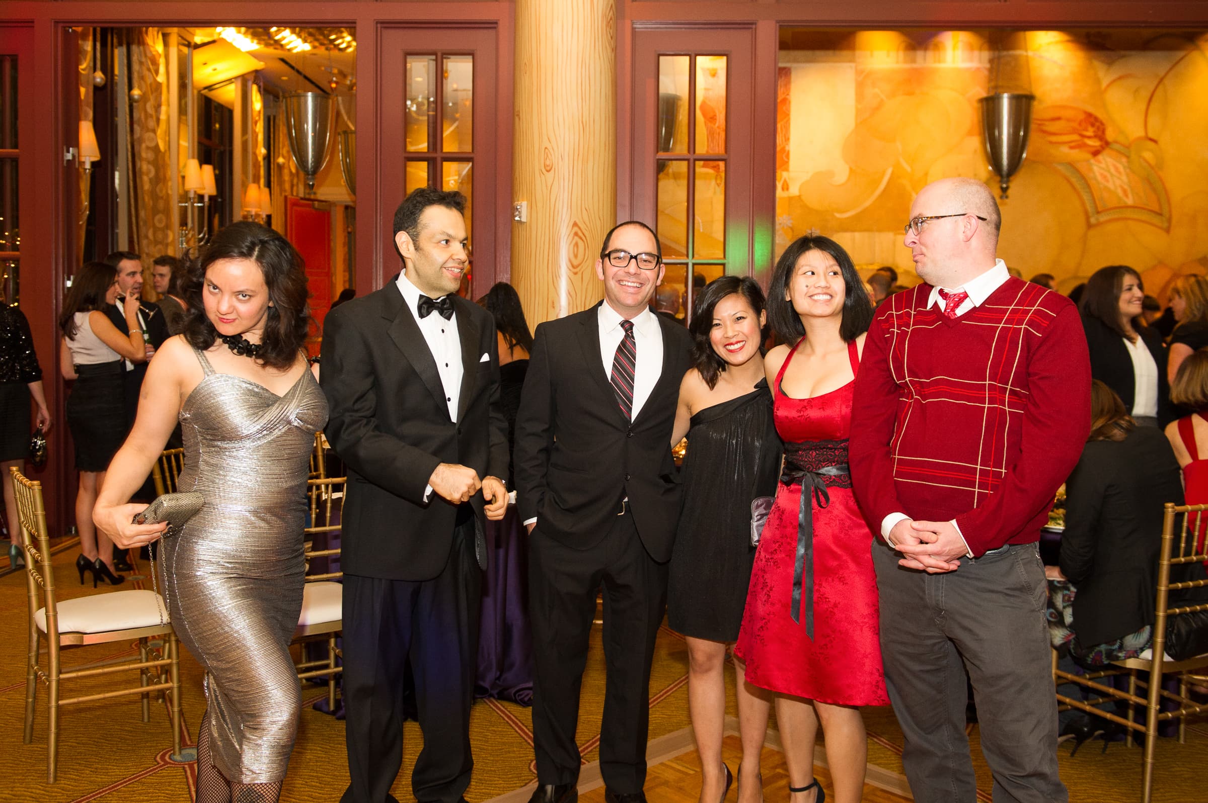 Six guests photographed together in a grand reception room