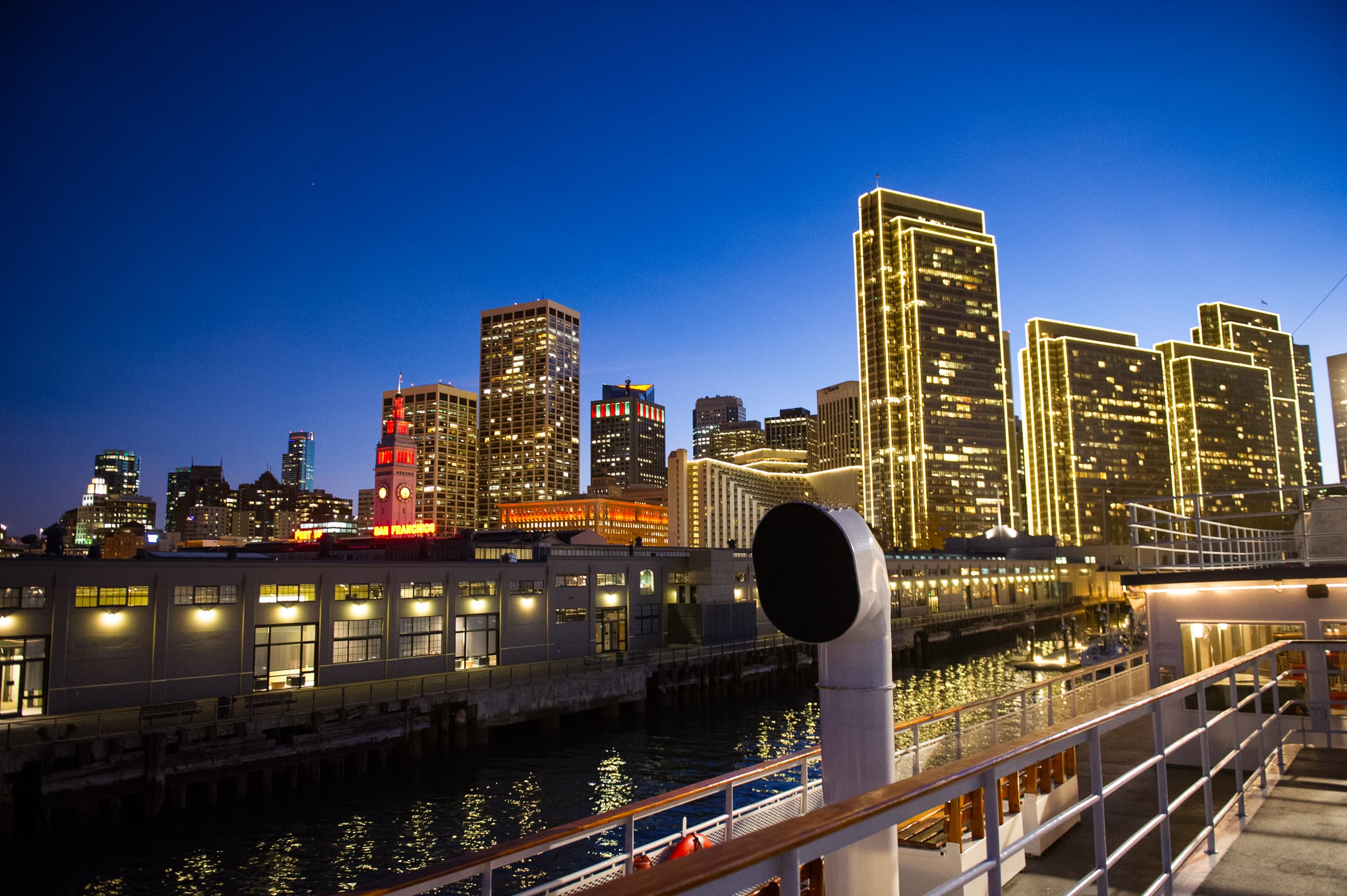 City skyline at dusk seen from a waterfront event venue