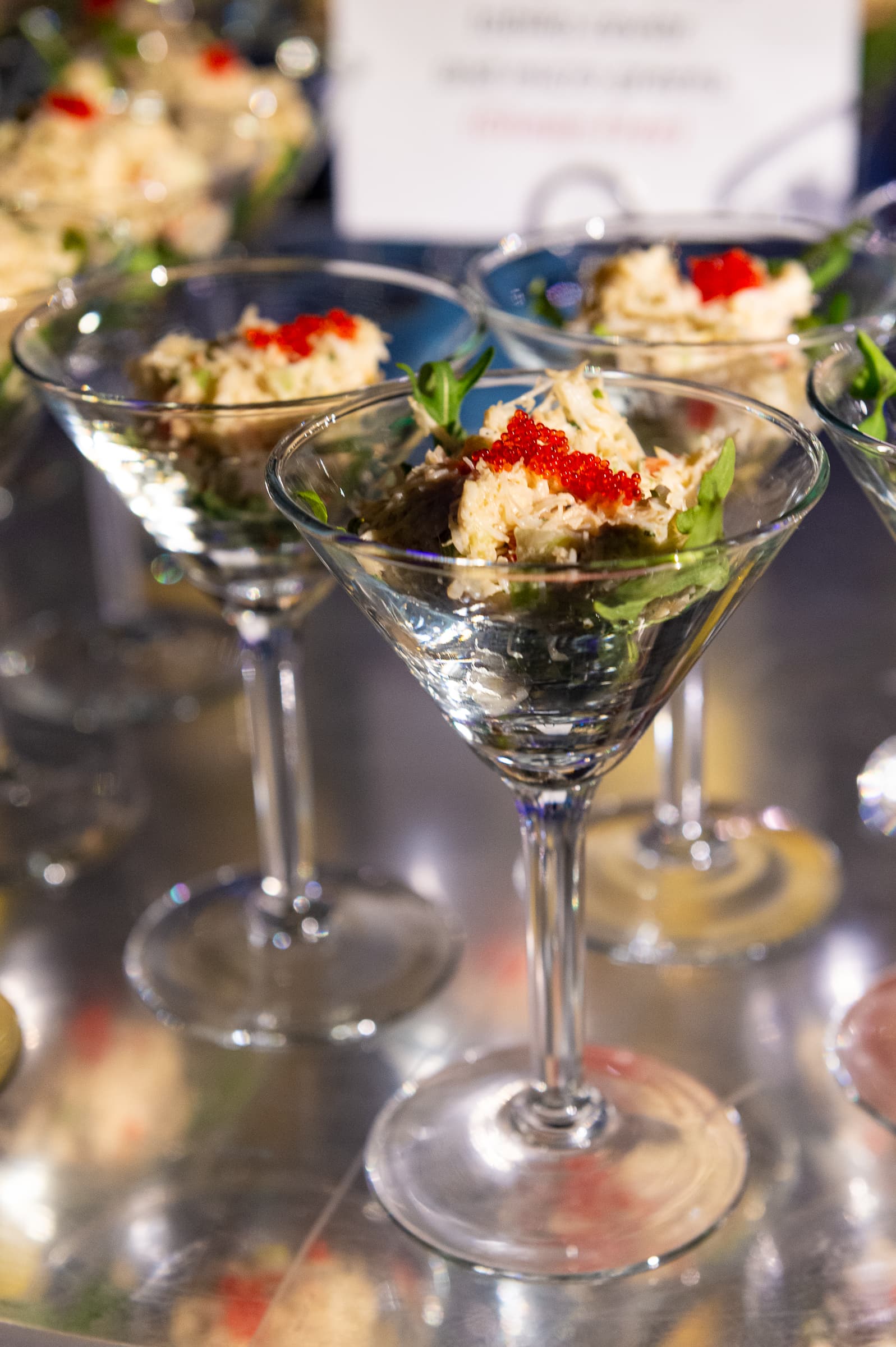 Layered dessert served in a martini glass with berry garnish